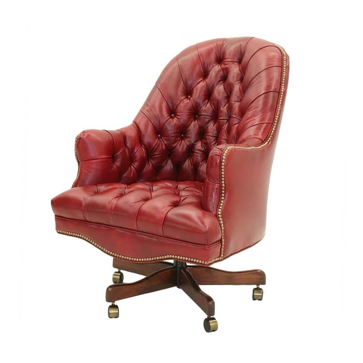 A fine customizable English style tufted Barrel back desk chair with tufted back and seat, an arched backrest with padded and upholstered arms, a shaped front rail with brass nailhead finishing details, a hydraulic lift to raise the seat and a