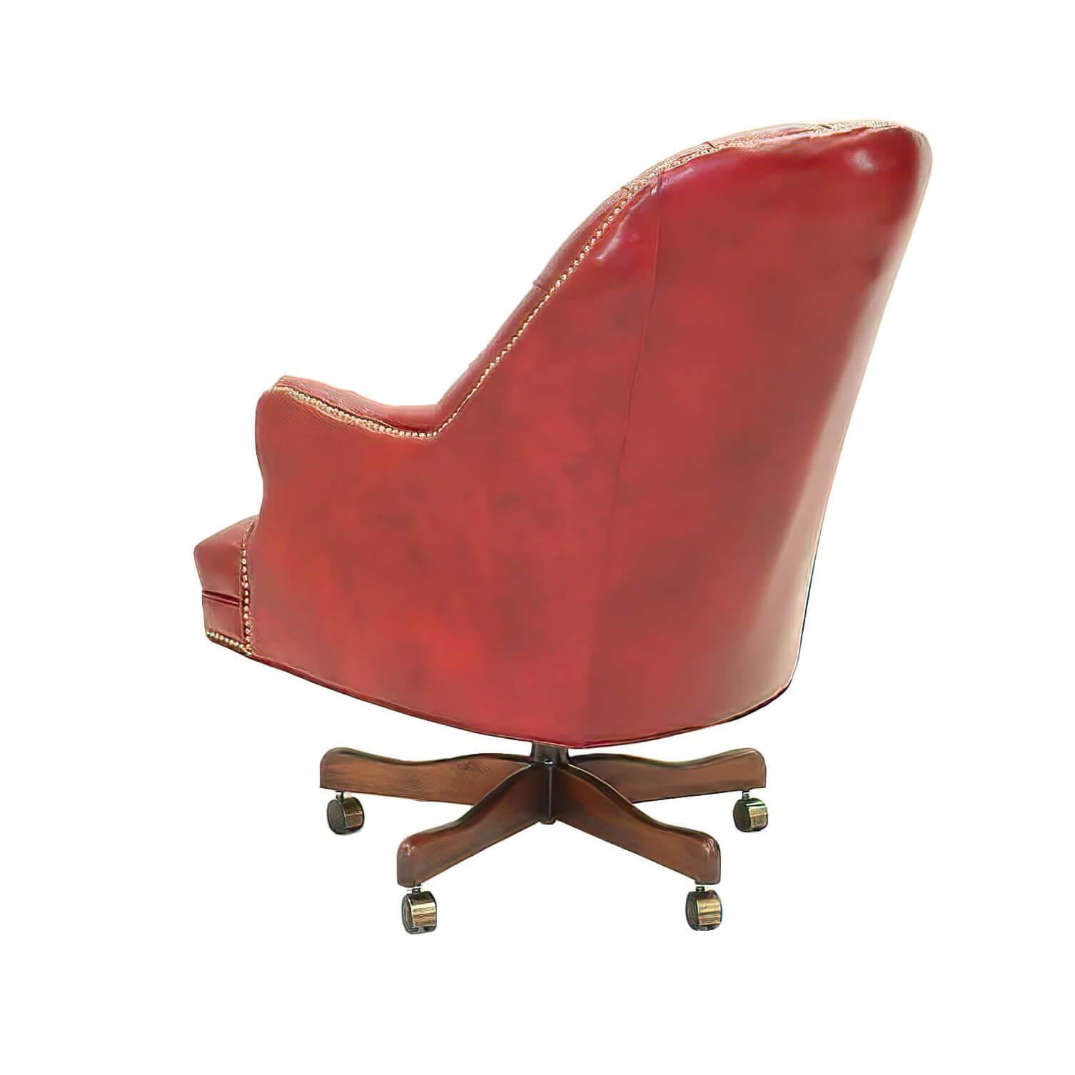A fine customizable English style tufted Barrel back desk chair with tufted back and seat, an arched backrest with padded and upholstered arms, a shaped front rail with brass nailhead finishing details, a hydraulic lift to raise the seat and a