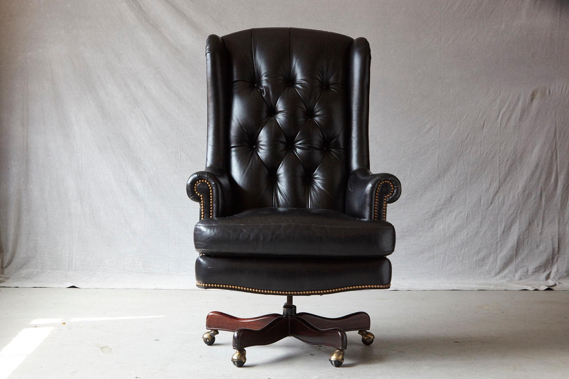 Very comfortable tufted black leather swivel and tilt executive chair with nailhead trim,
by Hancock & Moore, mounted on a mahogany base with casters.
Measures: Height 52.75 - 55.75 inches, seat height 22 - 25 inches, arm height 27 - 30