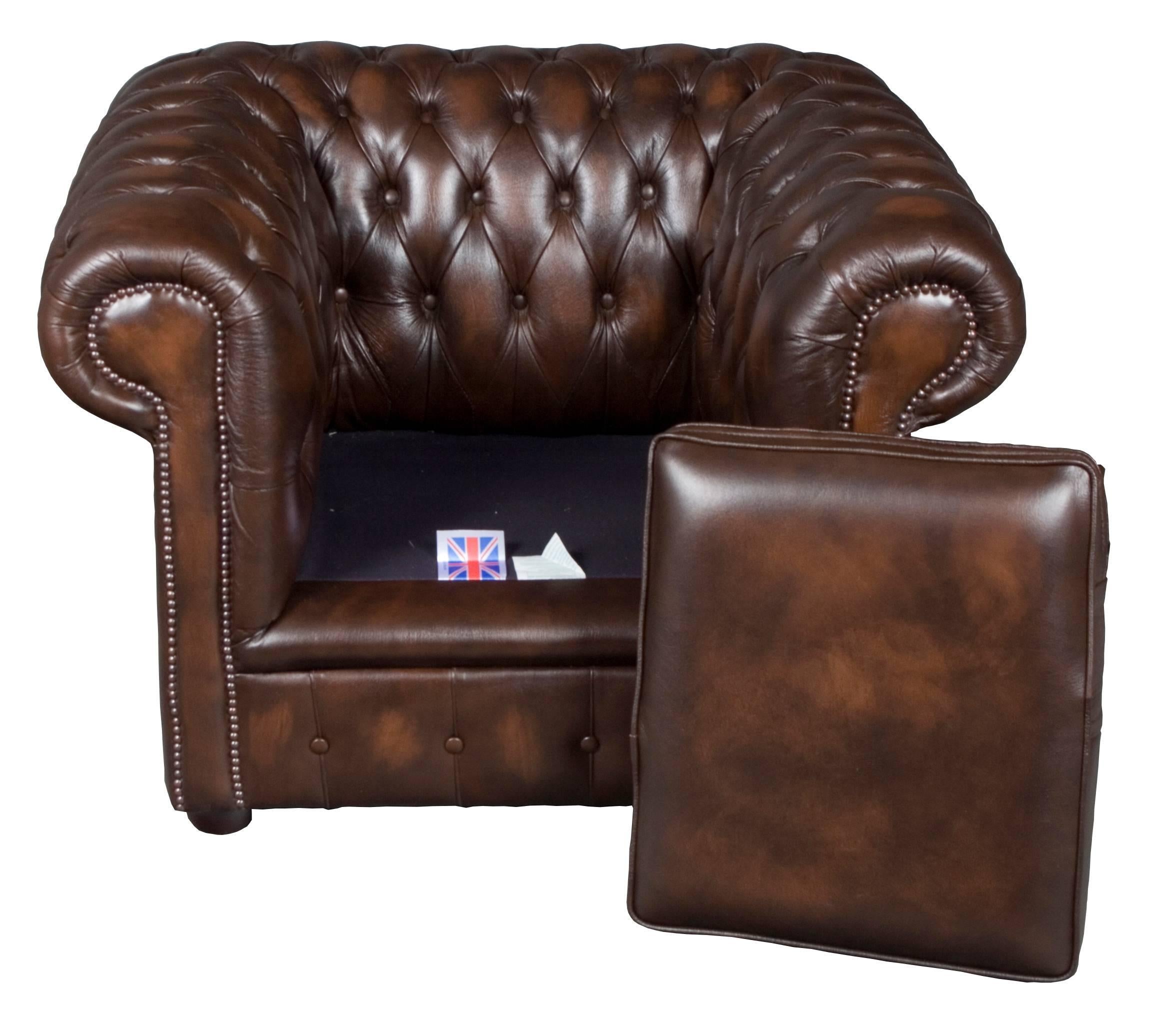 This gorgeous piece was made in England, circa 1980. It features beautiful tufted brown genuine, semi-aniline dyed leather and a sturdy hardwood frame.
The leather on this vintage club chair has darker and lighter tones of brown that seamlessly