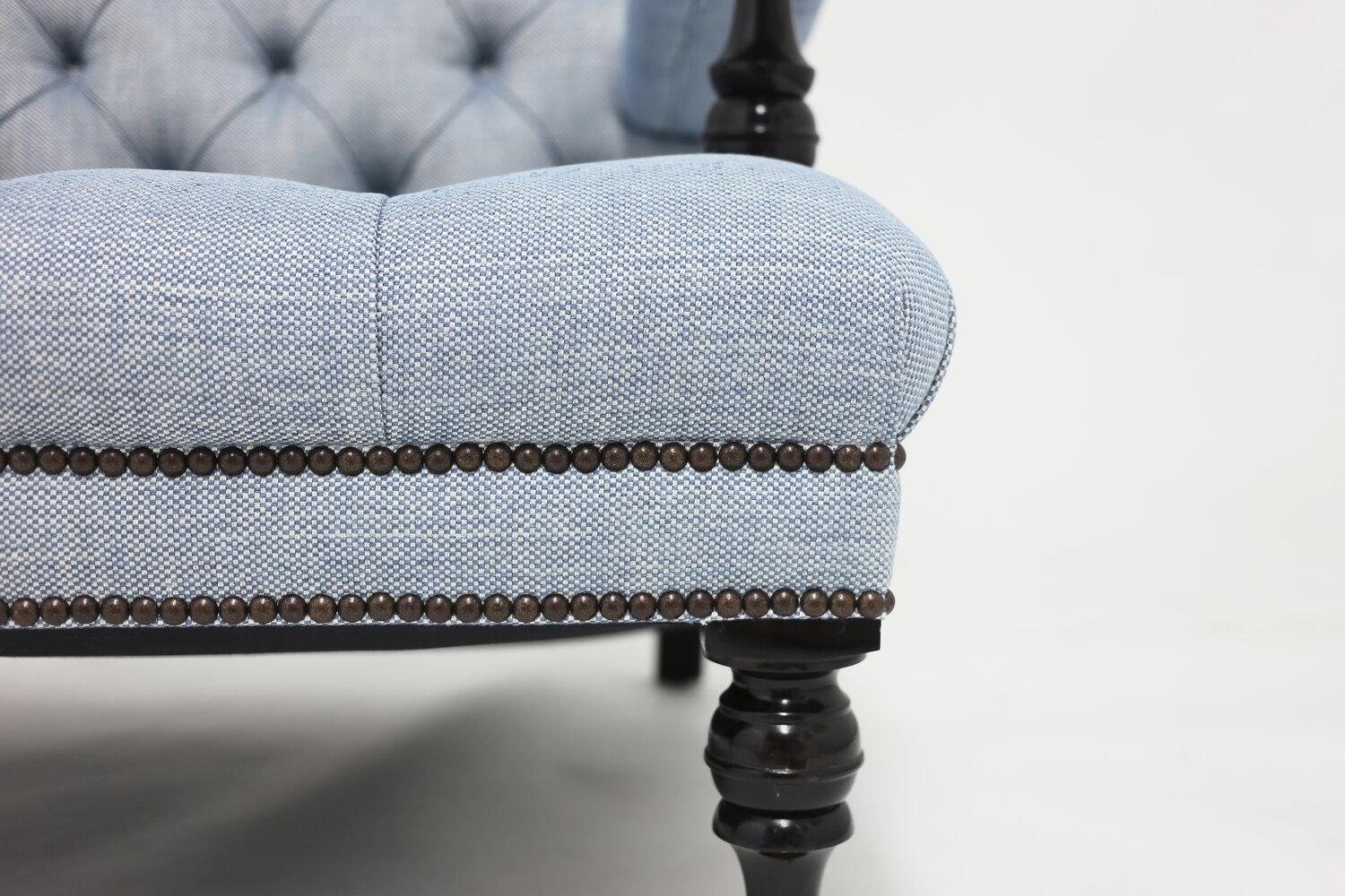 The Lewis club chair shown in blue linen fabric with tufted back and self covered buttons. All hair filled and stitched upholstery with hand carved dark mahogany wood legs and arm stretchers with special nailhead trim detail.
THIS ITEM IS NLY