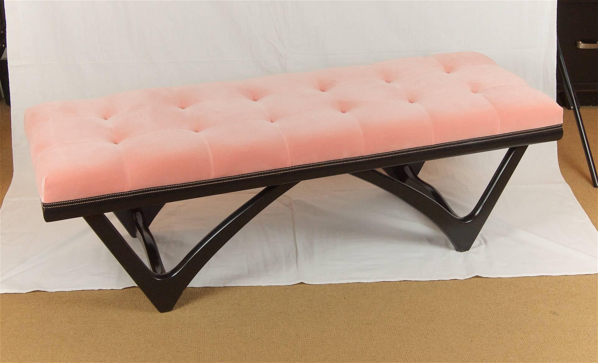 A well-sized long bench with a cantilever form base, newly lacquered in satin black. Upholstered in a tufted coral pink velvet by Brian del Toro Interiors, with black and silver pinhead trim.

 Perfect for the foot of the bed or a foyer.