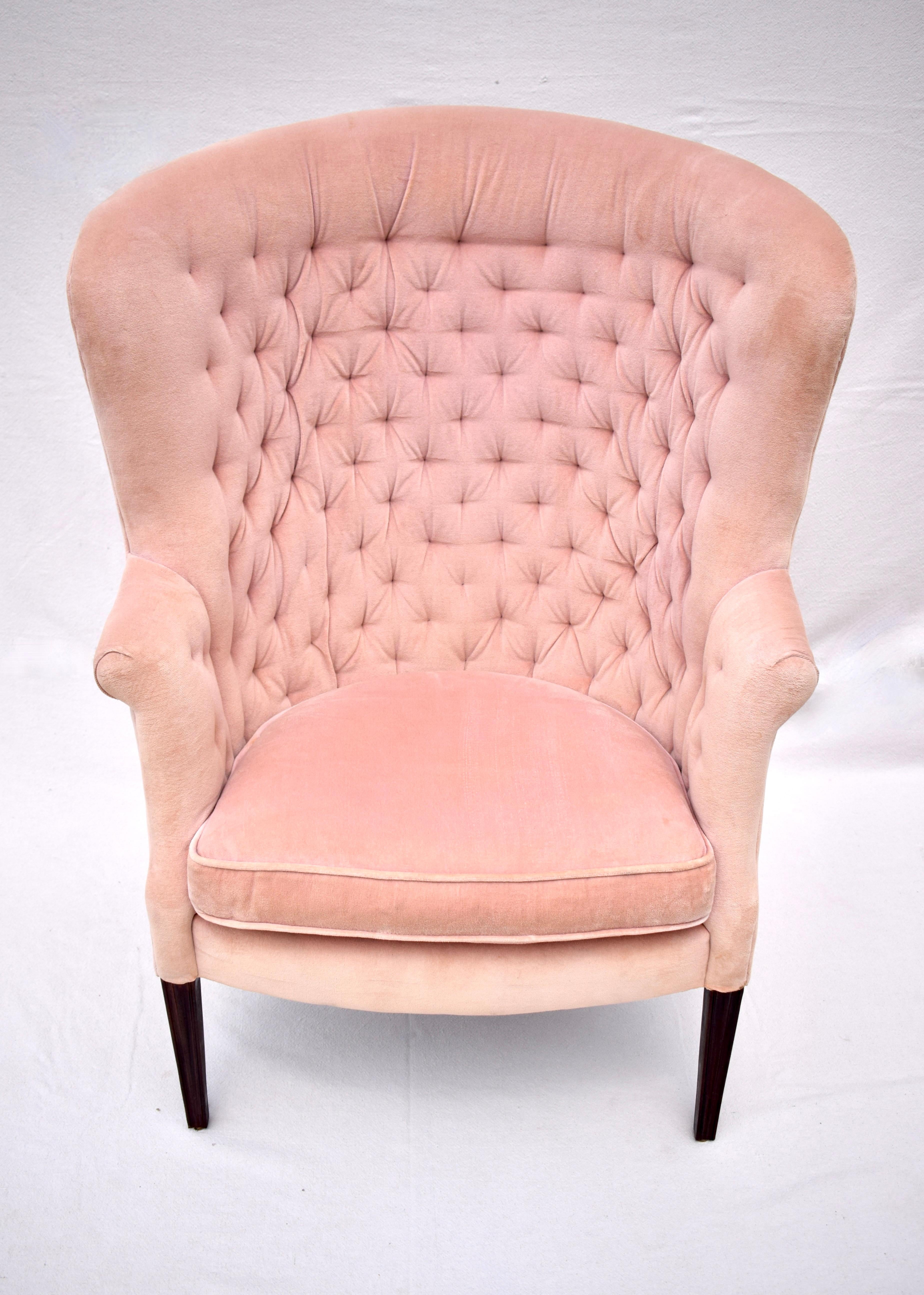 Sumptuous Edwardian Hepplewhite style Mahogany wing chair featuring curved back, scroll arms, tapered & splay legs upholstered in plush peach velvet. Marvelous tufted detailing. All original well maintained & professionally cleaned. seat: 21
