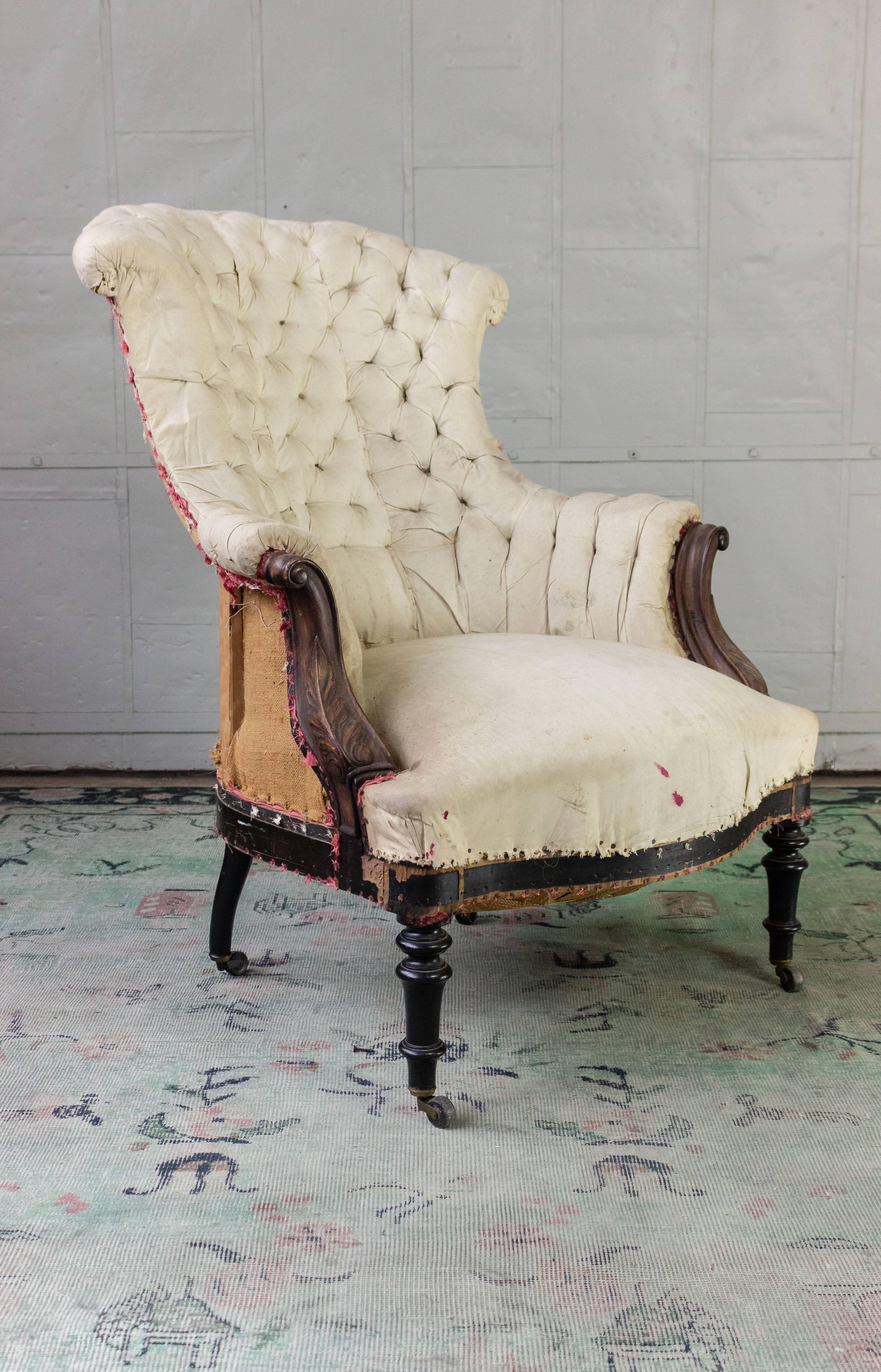 1920s armchair with elaborately carved details on arms which may have been originally gilt. The chair is stripped down to the muslin, ready to be upholstered. Sold as is. 
