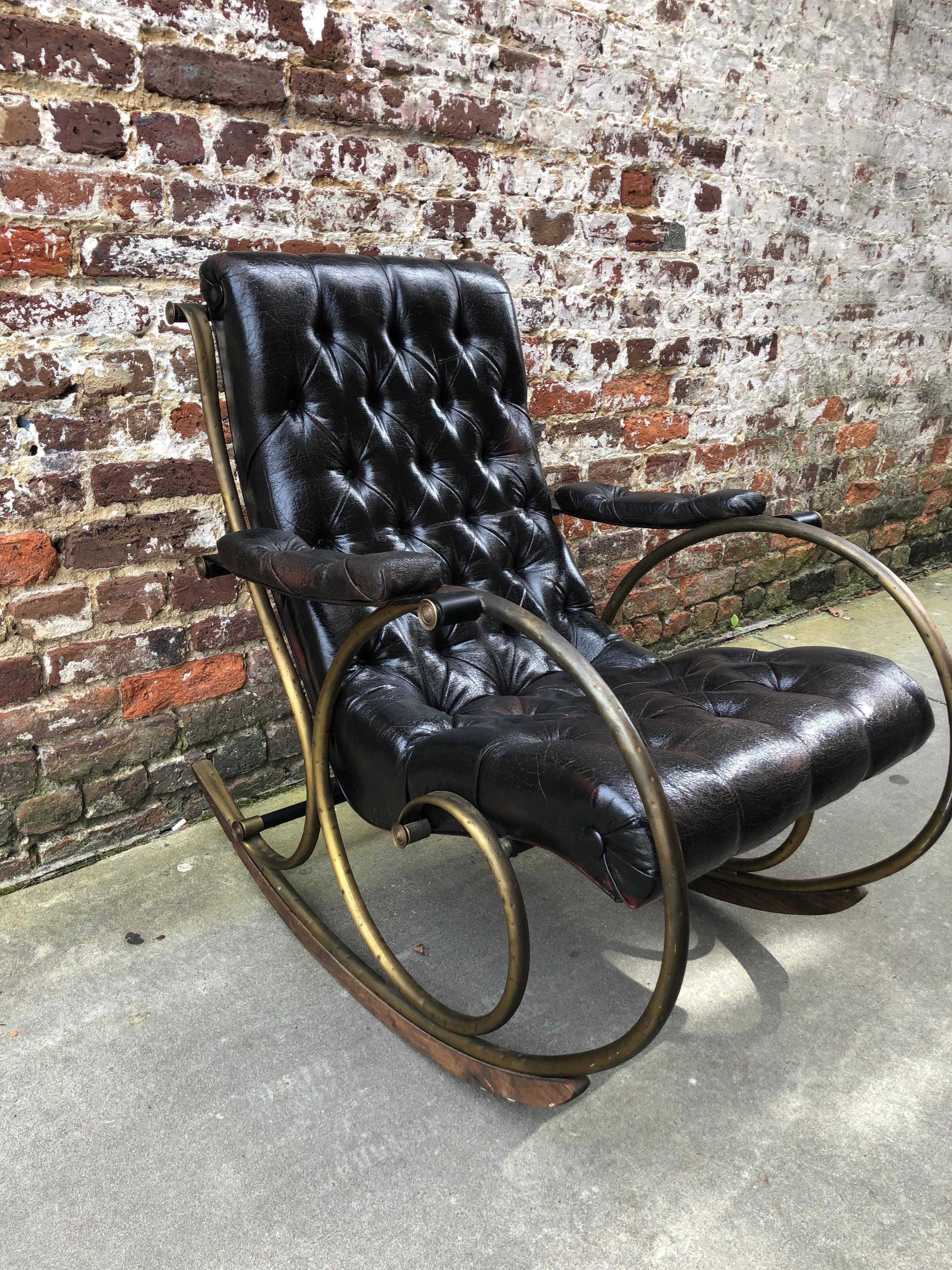 Tufted leather and brass rocking chair.