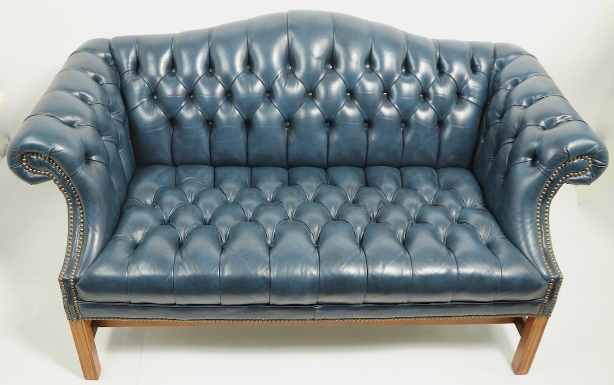 Stylish loveseat sofa in tufted dusty blue leather, with studded nail trim, on Chippendale style base. This example is in very clean, original and ready to use condition.
Chic, sophisticated, well crafted sofa of traditional design, which will also