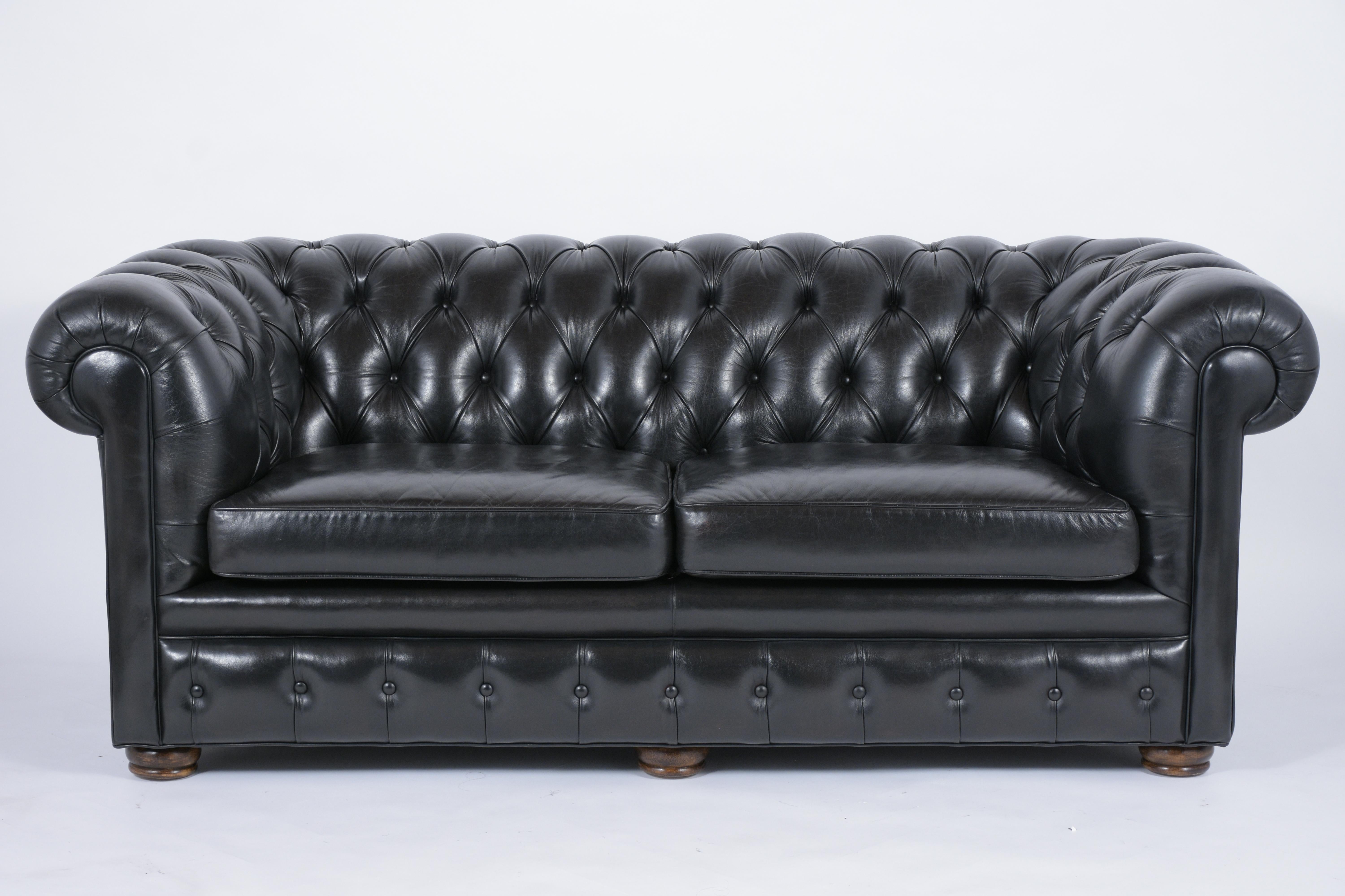 This 1970s leather chesterfield sofa has been professionally restored, comes with its original leather dyed in a very dark brown color, and newly polished patina finish. The sofa features a tufted design on the arms & backrest, single piping details