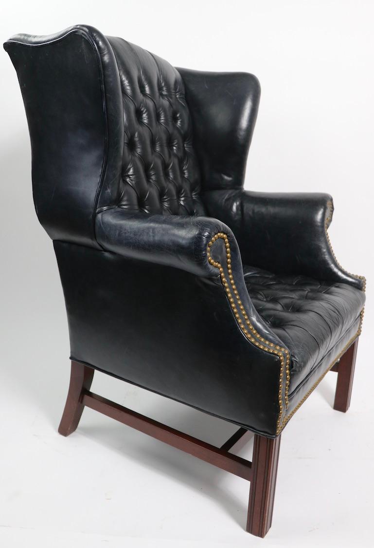Chic and stylish wingback chair, in very dark blue tufted leather with brass nail head studs, this example is in wonderful distressed, but not damaged condition, perfect for reading, relaxing or just showing off.
20th century vintage, measures:
