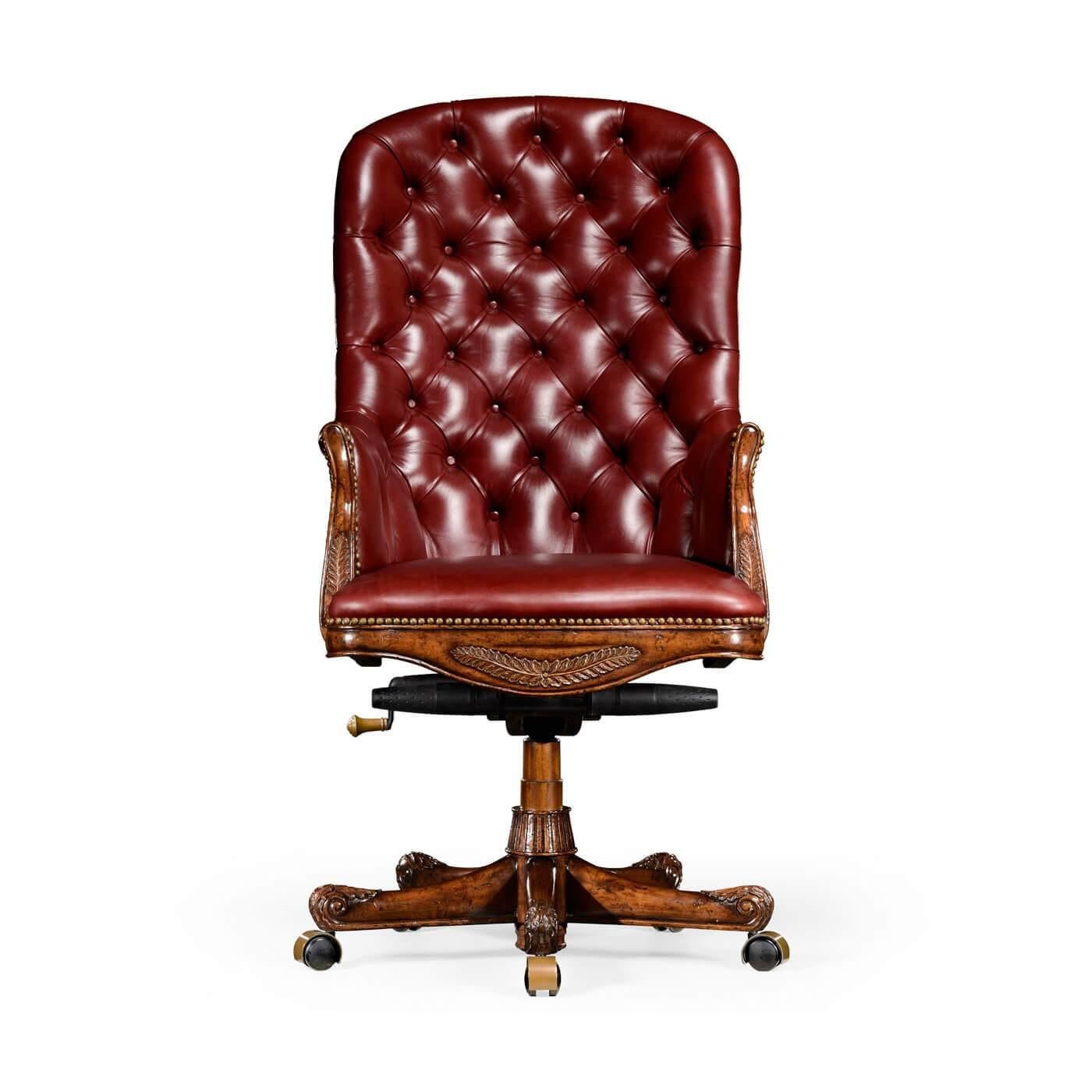English style buttoned and studded burgundy red leather desk chair with a mahogany frame, fully adjustable and set on five legs with castors and finely carved details. High back.

Dimensions: 27.25