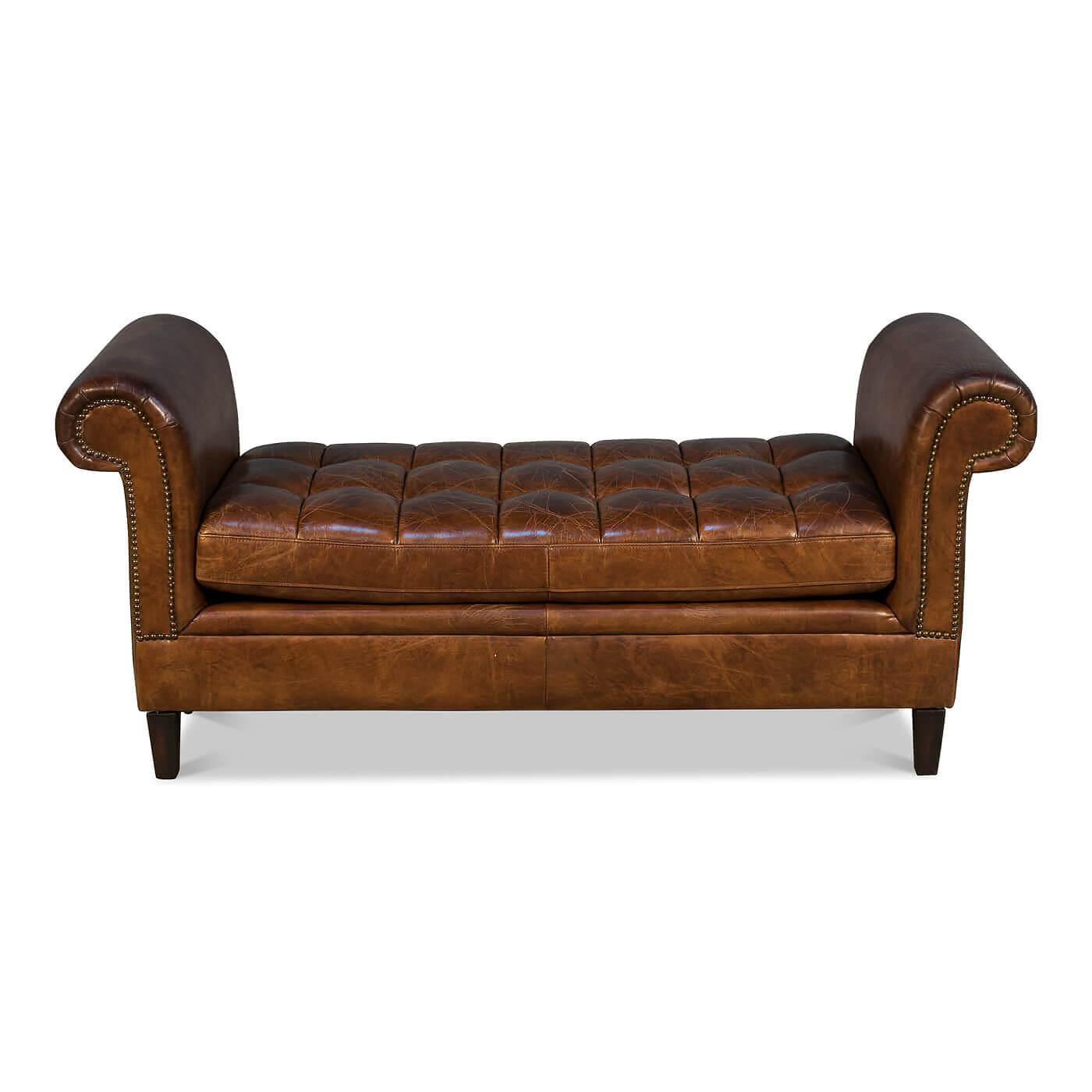 A tufted leather scroll arm window bench with nailhead trim. This piece has a timeless classic look with its rolled arm design and traditional rich brown color. The center seat cushion features button tufting, and the benches frame is accented with
