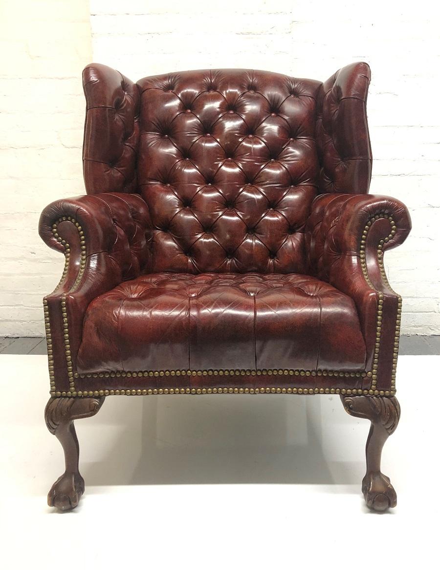 Tufted leather wingback chair with matching ottoman. The chair and ottoman both have burgundy tufted leather with claw and ball feet.
Chair measures: 41 H x 34 W x 34 D
Ottoman measures: 17 H x 27 W x 20 D.