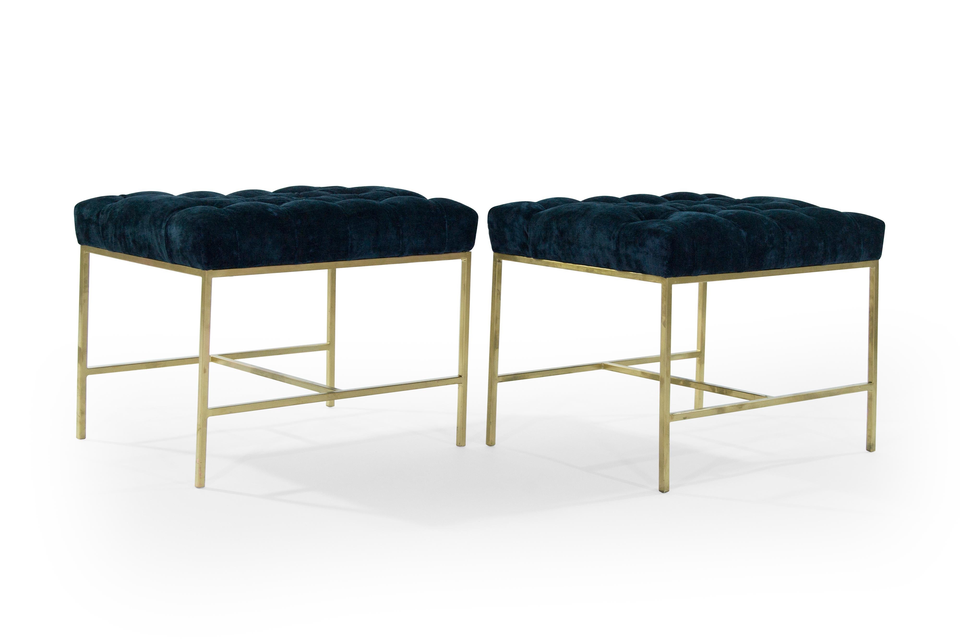 Pair of brushed brass stools or benches in the style of Paul McCobb, newly upholstered in navy chenille with tufted detail, circa 1950s.