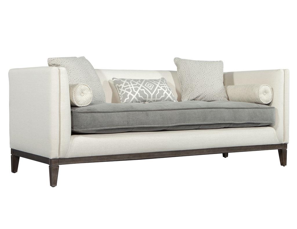 Tufted modern grey and cream Bailey sofa. Rich in character and plush in texture, the Bailey sofa is a whole home furnishing with performance fabric upholstery, button-tufted seat cushions, and a run of lux pillows including two bolsters.

Price
