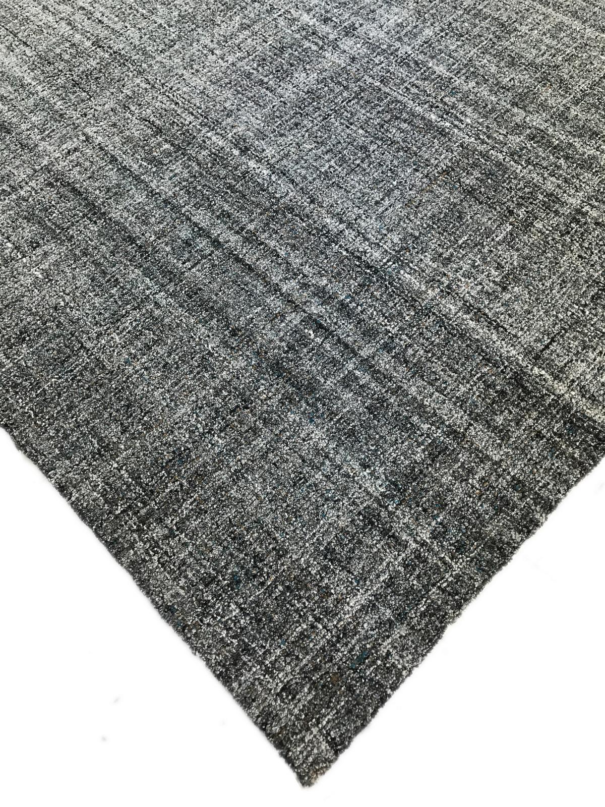 There's definitely more to this rug than meets the eye! At first glance this rug appears to be a straight forward blend of black, grey and silver but a closer look reveals turquoise, gold and other colors scattered throughout like gemstones in
