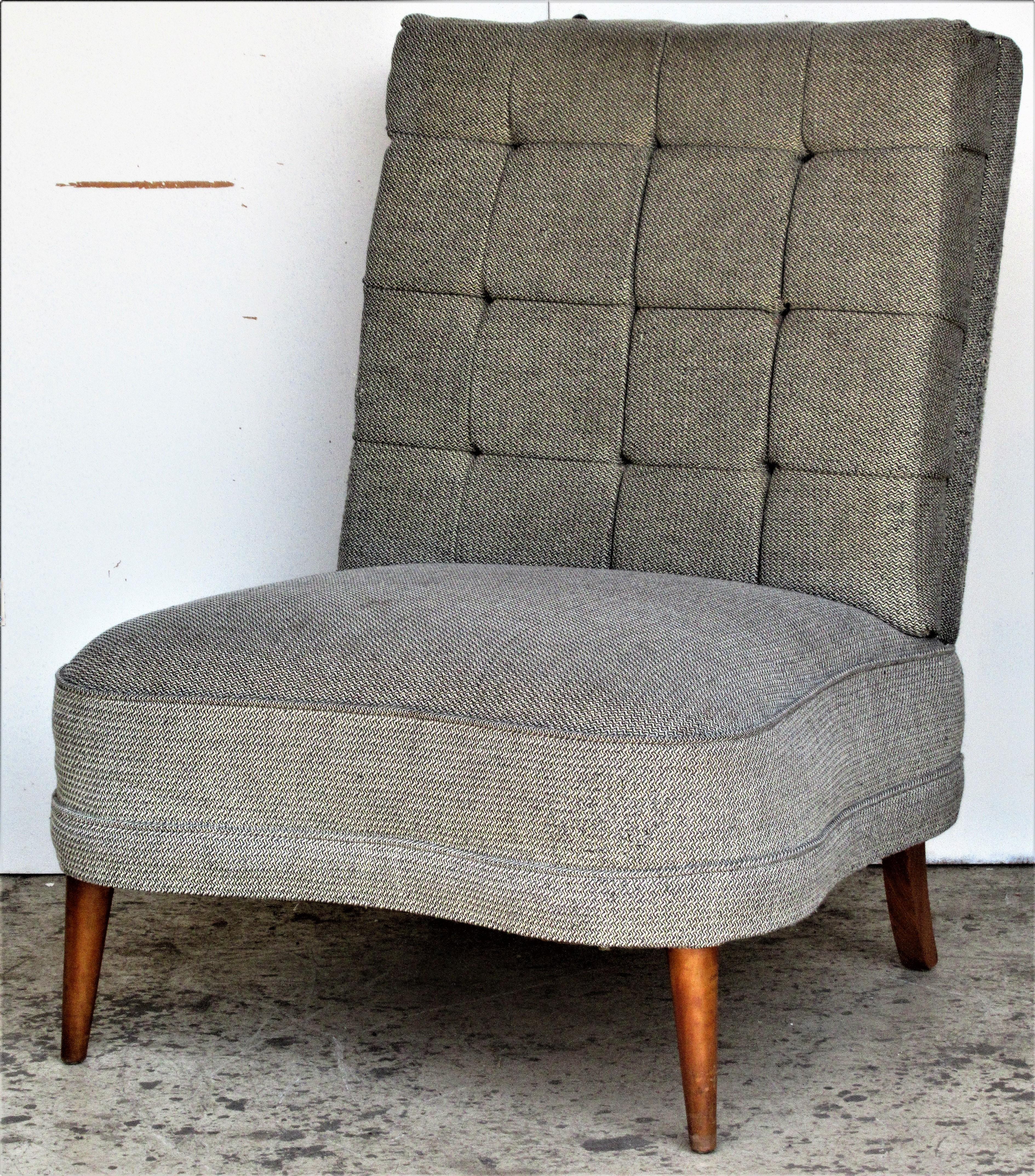 A substantial size tufted back curved seat slipper lounge chair raised on four tapered wooden legs in the original metallic thread upholstery. In the Hollywood Regency style of William Billy Haines, circa 1940-1950.