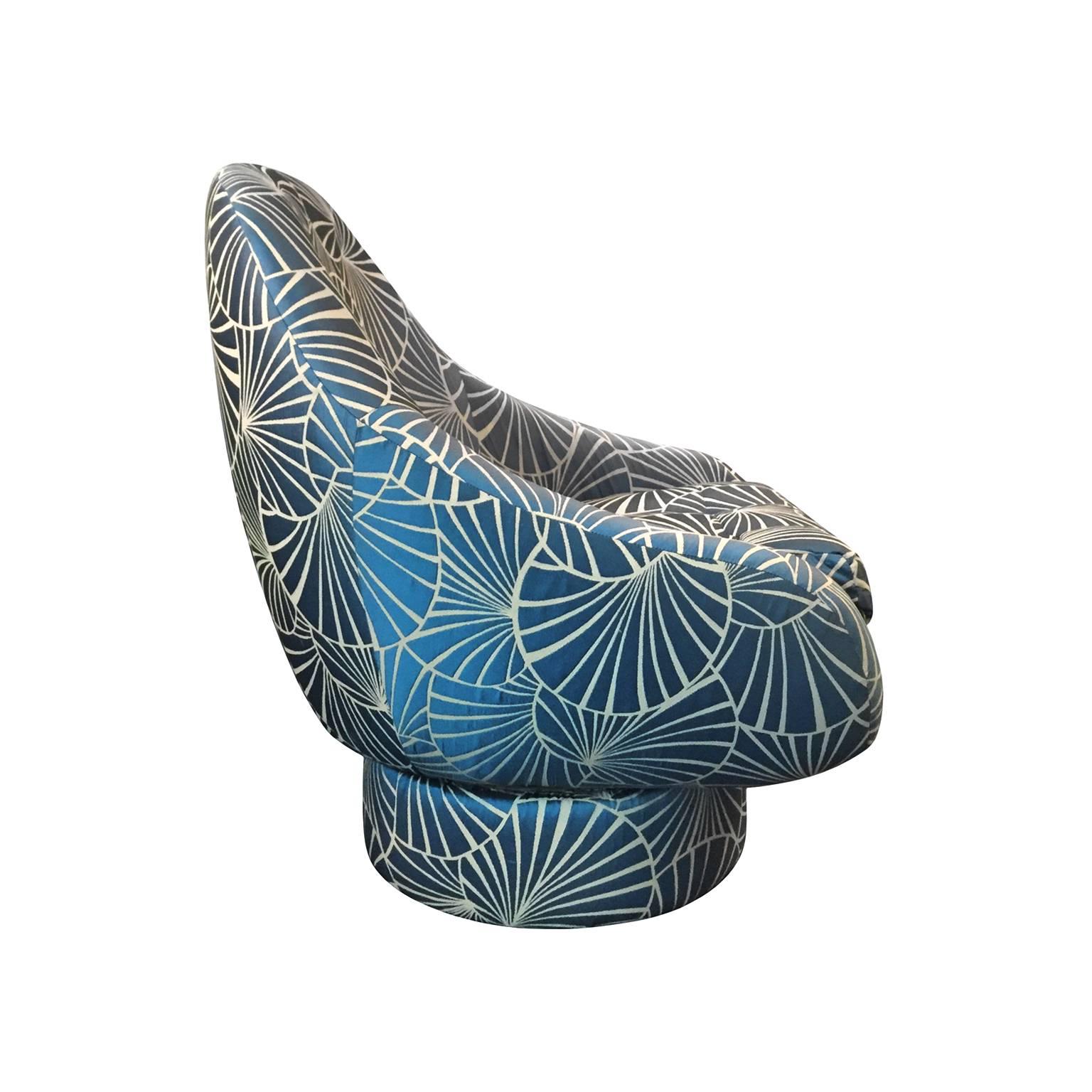 Tufted swivel chair by Steve Chase, newly upholstered in a blue frond fabric, USA, 1970s.
