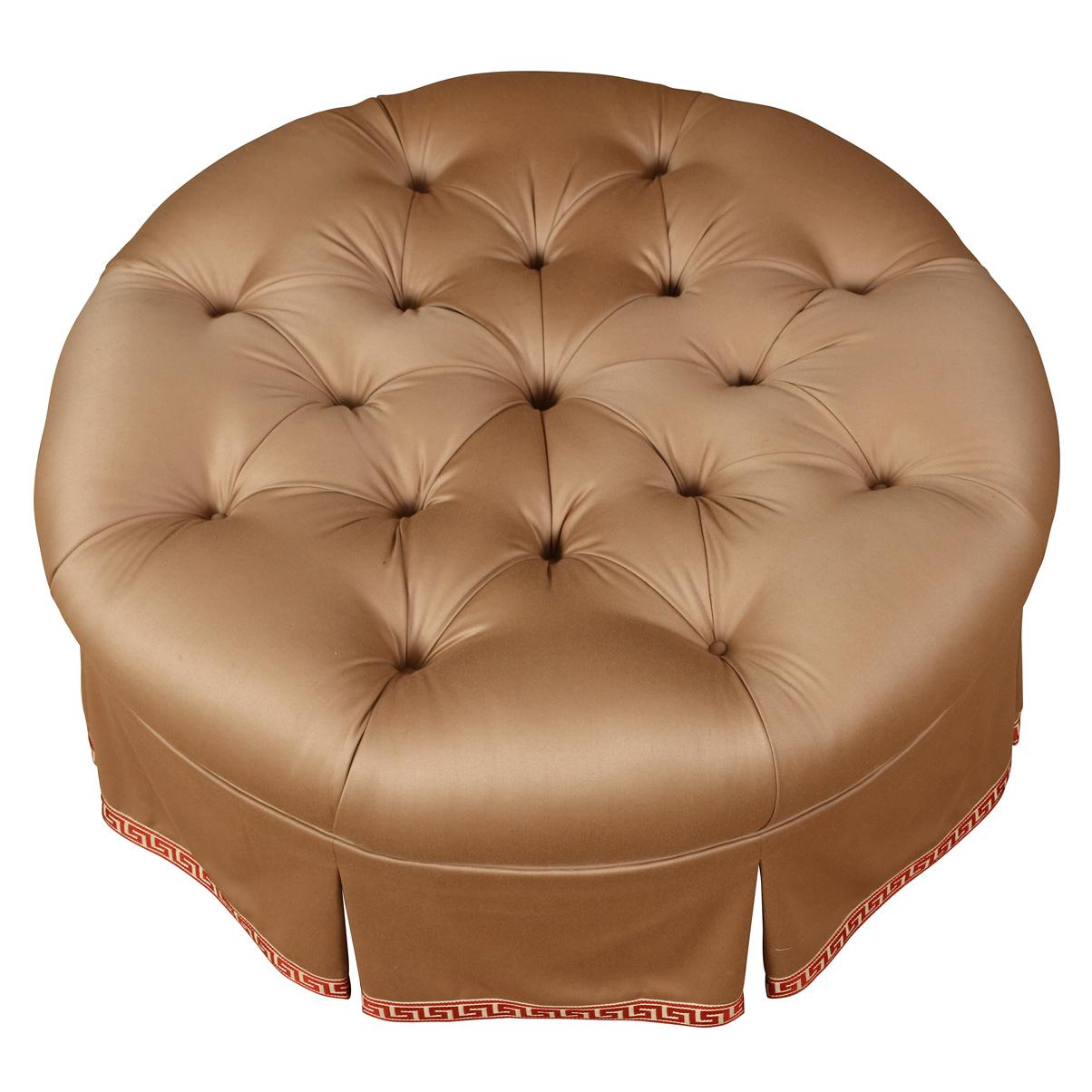 This large tufted ottoman exudes timeless elegance with its beautifully tailored skirt and luxurious detailing. The piece has been upholstered in a lovely, neutral wool. a classic The box-pleated skirt , finished in a fGreek key tape trim, adds a