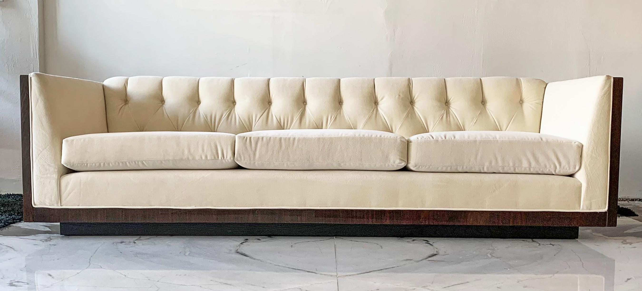 Available right now I have this stunning Milo Baughman style rosewood case sofa. This sofa is completely wrapped in the most gorgeous rosewood and sits on an ebonized plinth base. The sofa has been masterfully reupholstered in a creamy ivory velvet