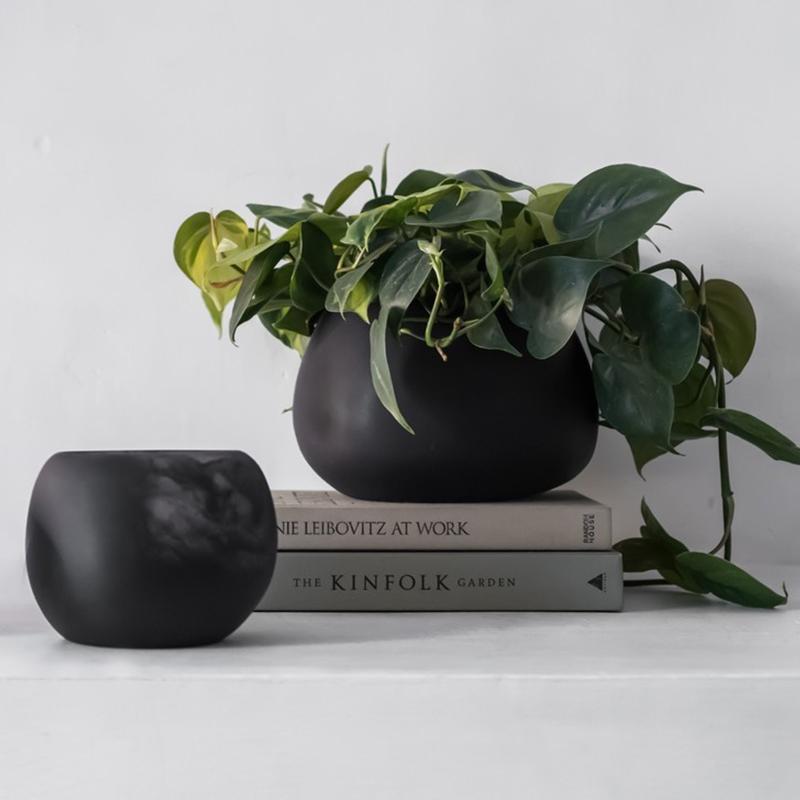 A unique resin vase for flowers, plants, or just as decor

This resin vase comes in two variations: one is all black resin, and one is made from a mix of black and clear resin that blend together in swirls and clouds reminiscent of ink dissolving in