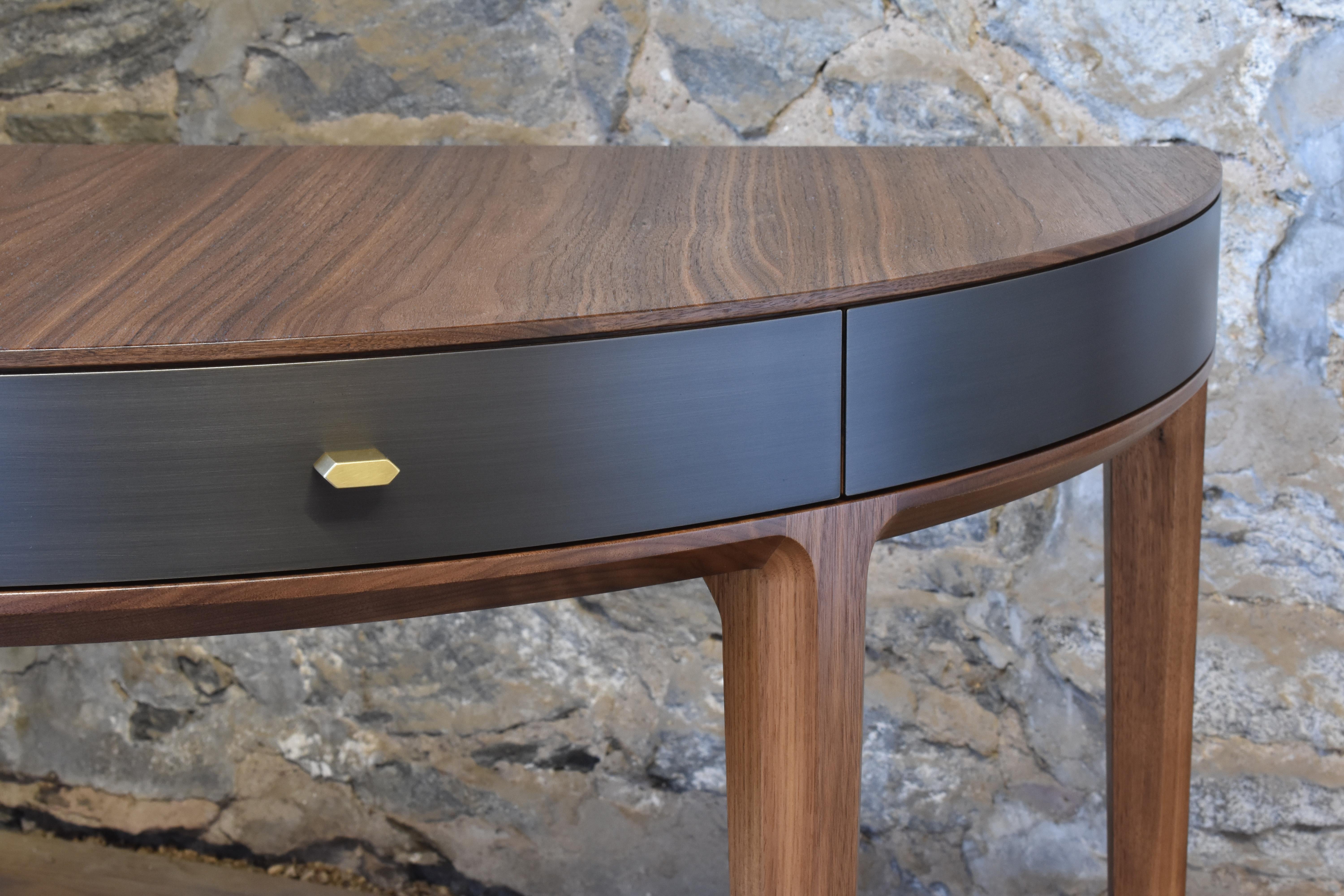 Shown in oiled walnut and gunmetal steel with burnished bronze hardware, the Tulare demilune desk features two solid wood drawers, custom made hardware and hand applied finishes.
Dimensions (as pictured): 48