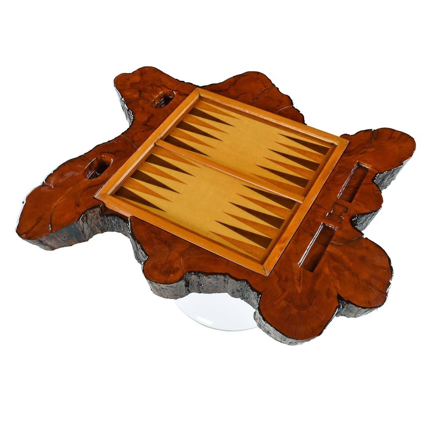 This unique vintage cypress root chess/backgammon gaming table is constructed of live edge cypress slab. The centre of the slab hosts a reversible game board. One side for backgammon, flip to reveal a chess or checkerboard field. Gullies along the