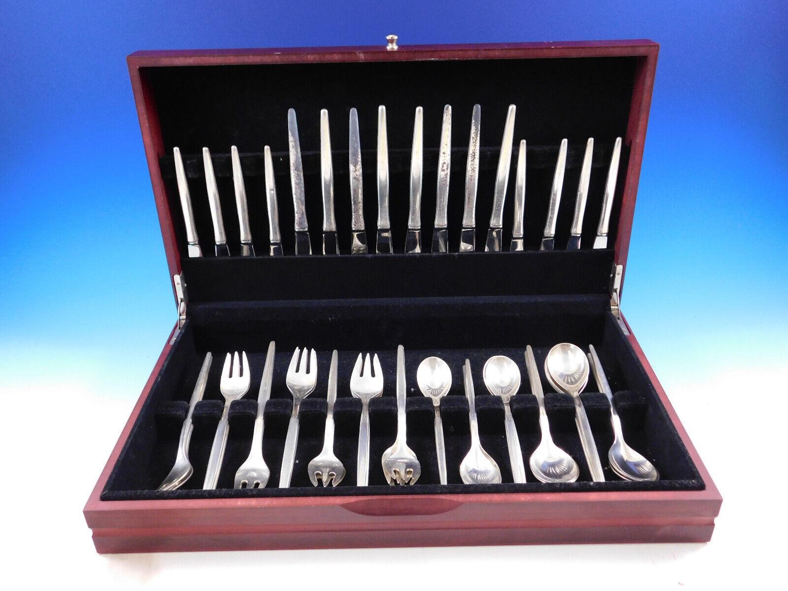 Stunning Scandinavian Modern Tulip by A. Michelsen sterling silver Flatware set with modern elongated handles, 48 pieces. This set includes:

8 Knives, 8 1/2