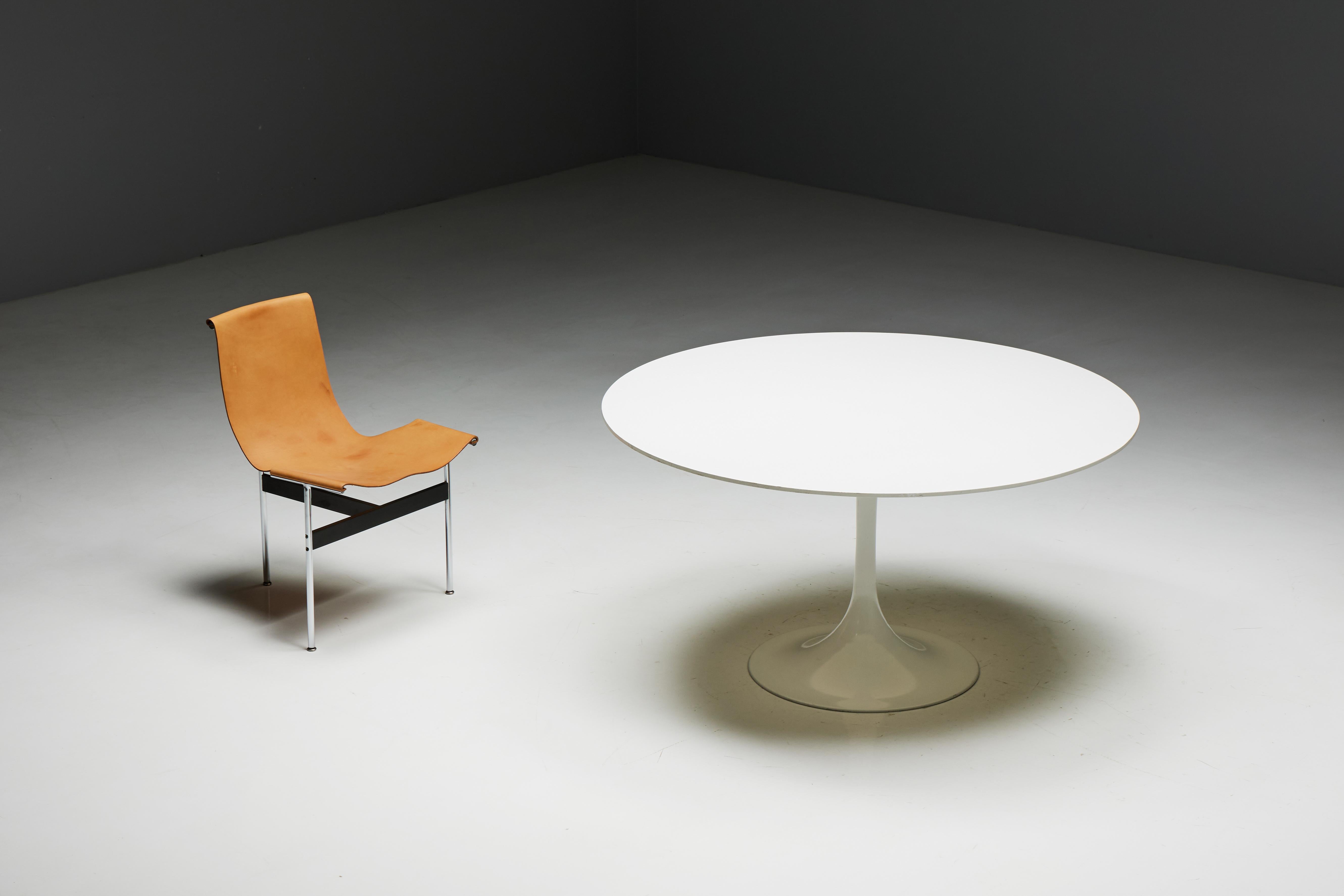 Round dining table by Eero Saarinen for Knoll International, originating in the United States in the 1970s. This table is crafted with an elegant aluminum tulip base and a sleek laminate top in pristine white. The spacious round design comfortably