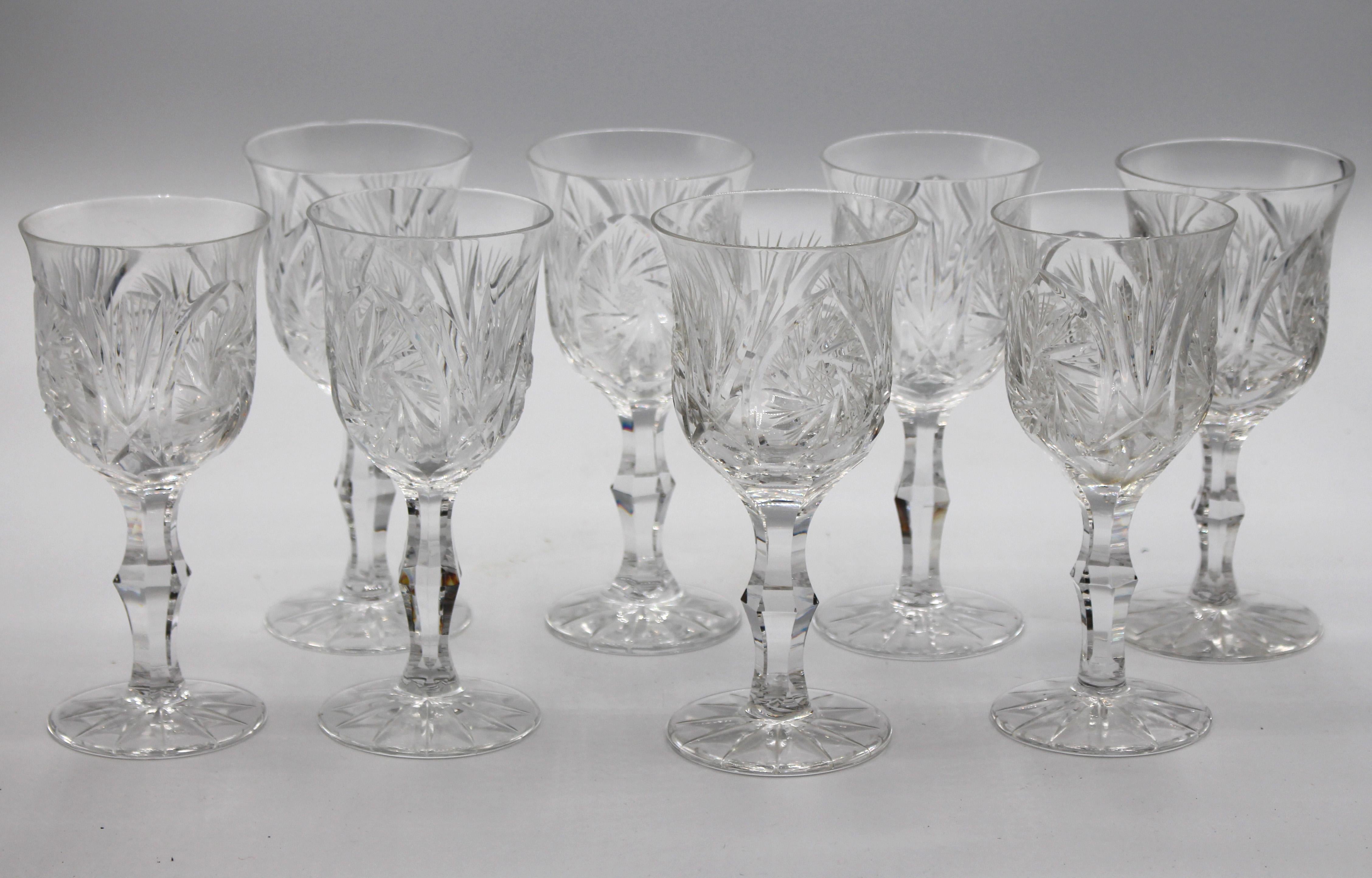 An elegant set of eight wine glasses - tulip form, handblown, American brilliant cut glass. Each raised on shaped and panelled stems. 5 3/4