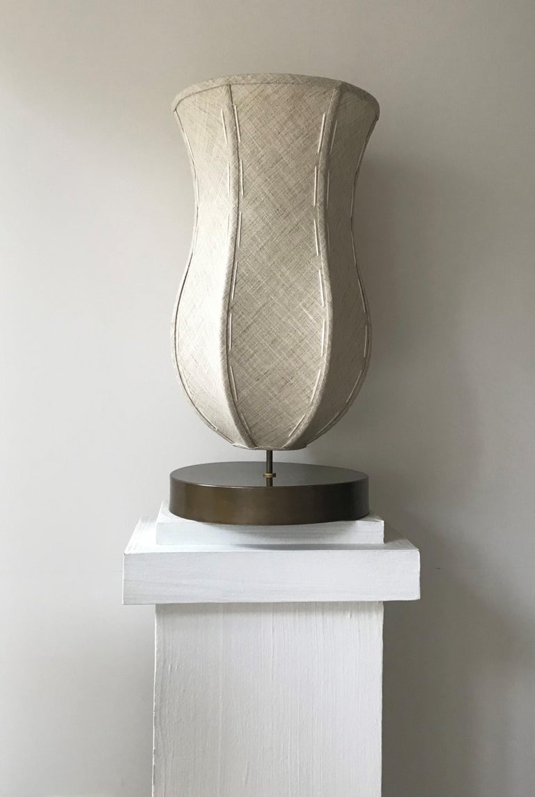 Tulip Lamp is a versatile example of organic modern design that refers to early 20th century Cubism and nature. Tulip Lamp offering useful light levels and a highly decorative curved, minimal shape. Standing on its patinated brass base, Tulip Lamp