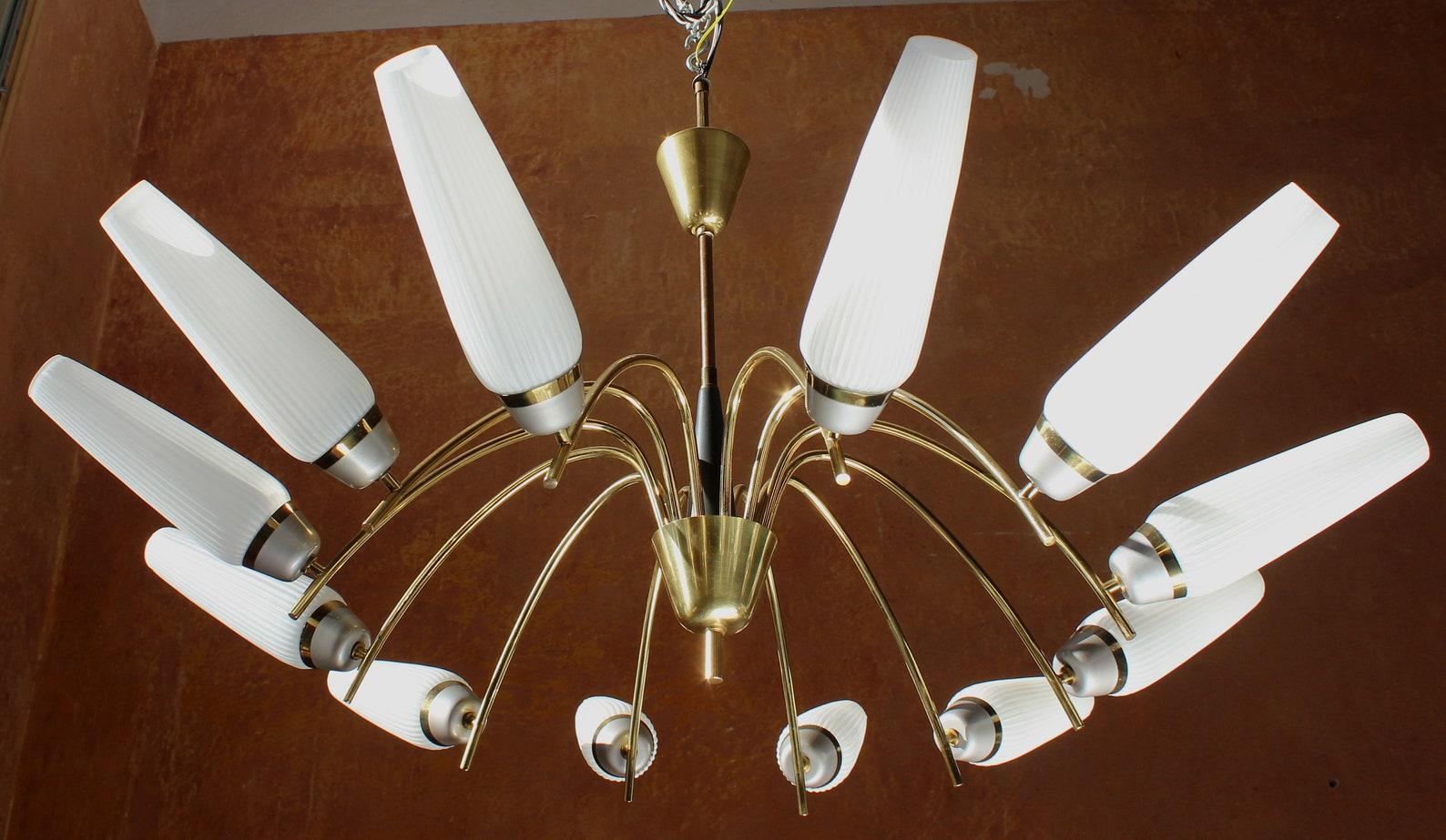Elegant brass spider chandelier 12 lights E14 with opal glass tulips, Germany 1950s. 

Elegant 1950s German 12 lights E14 white spider chandelier Stilnovo type stream

German design from the 50s to 70s is leaving the world some valuable modern