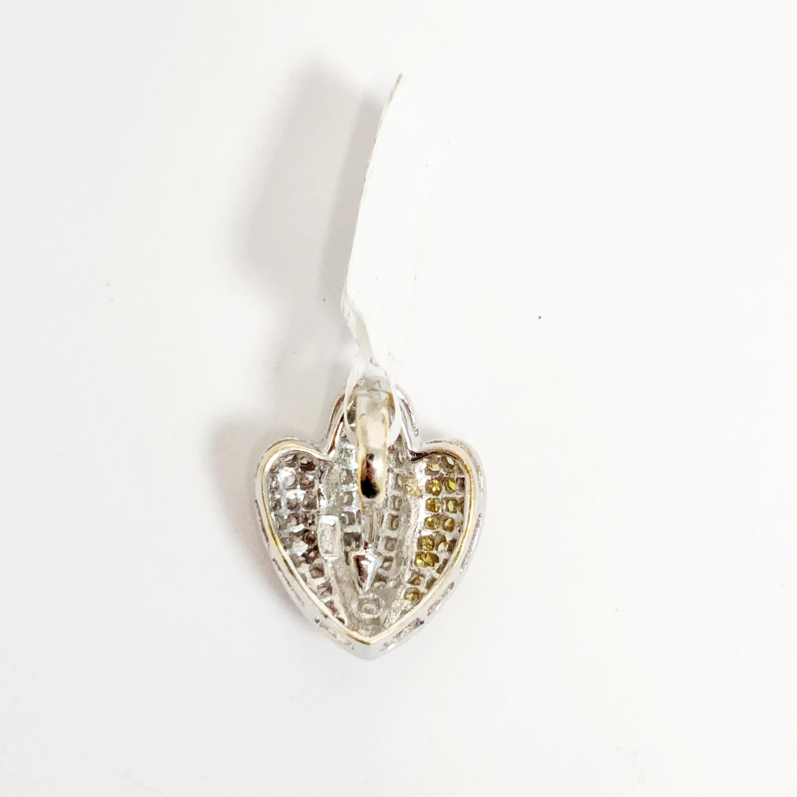 This exquisite pendant features a stunning tulip design, crafted from a combination of 18K yellow, white, and rose gold. The petals of the tulip are adorned with a dazzling array of white, yellow, and pink melee diamonds, creating a breathtaking