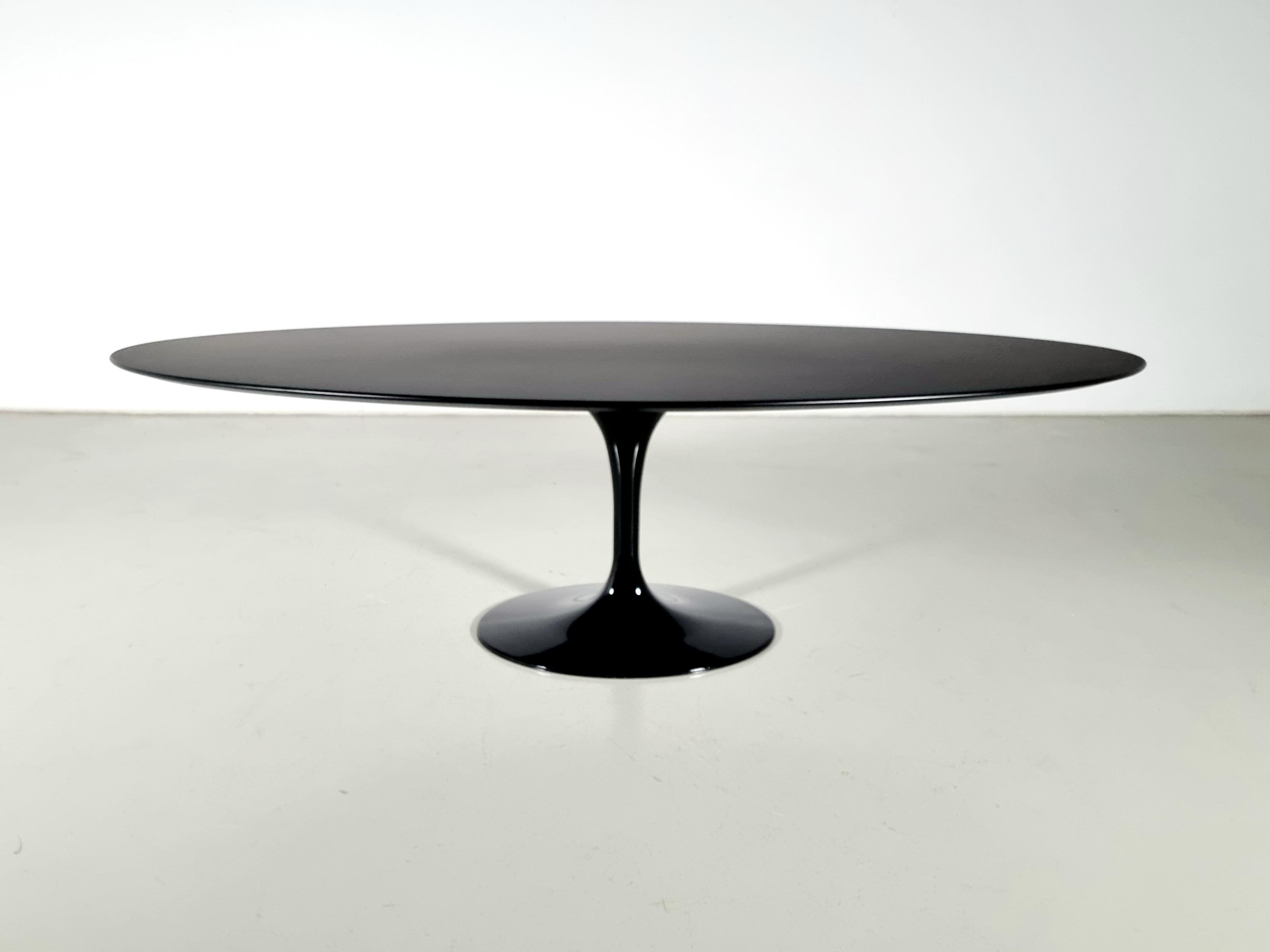 Tulip dining table by Finnish designer Eero Saarinen for Knoll International. The table has a beautiful black smooth laminate top and black base, marked.

The Knoll International Saarinen dining table was created between 1955 and 1957 and is based