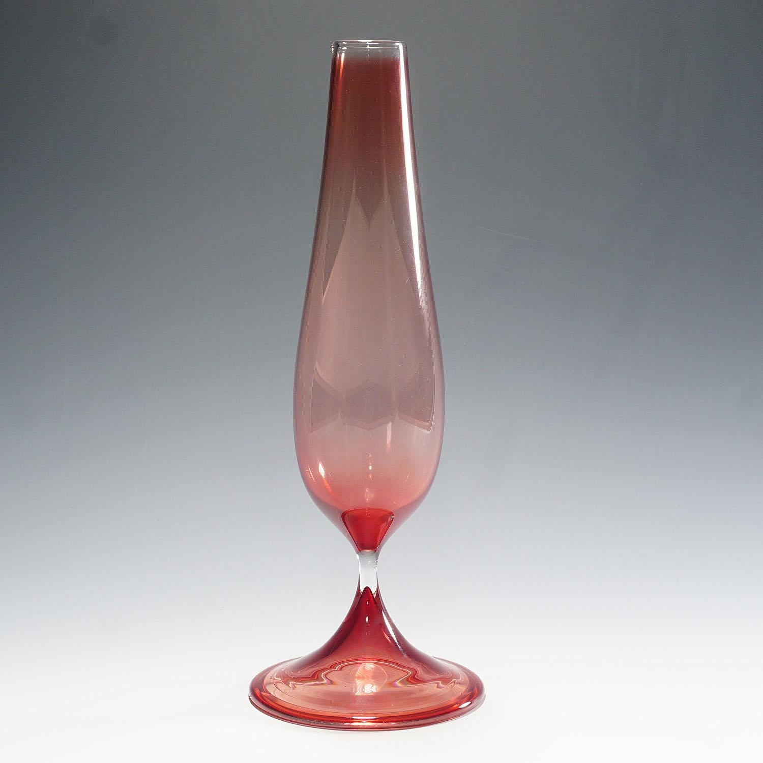 Stylish 'Tulip' vase with elongated, fluting body on a slender column and flaring base in light red and clear coloration. Designed by Nils Landberg and produced by Orrefors, Sweden in 1957. A superb example from this iconic series. Engraved