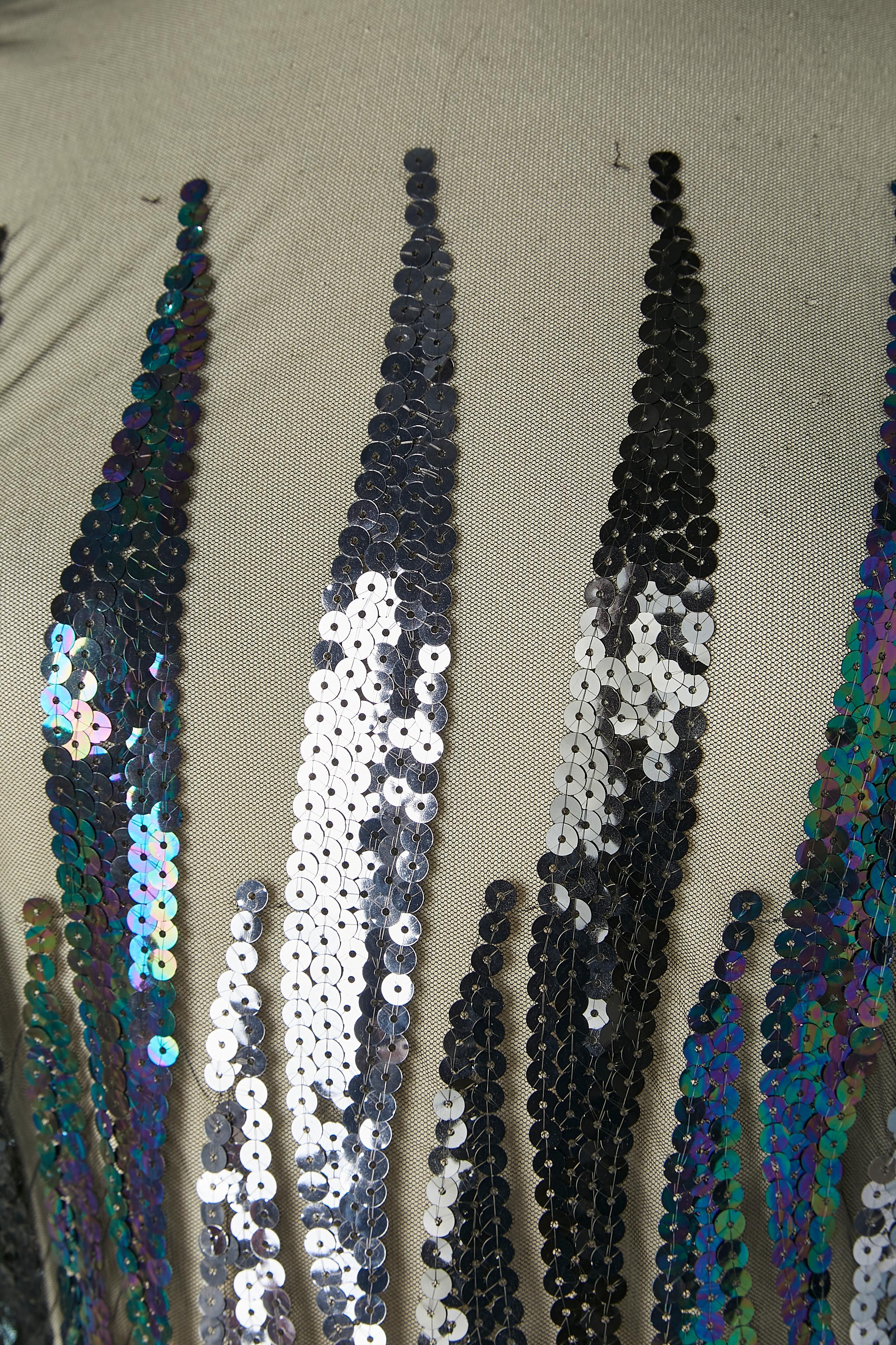 Tulle and sequin cocktail dress. No fabric composition tag but the tulle is probably polyester. Stiff tulle on the bottom. 
Zip closure on the middle back + Hook&eye on the top.
SIZE 38 (Fr) / M 