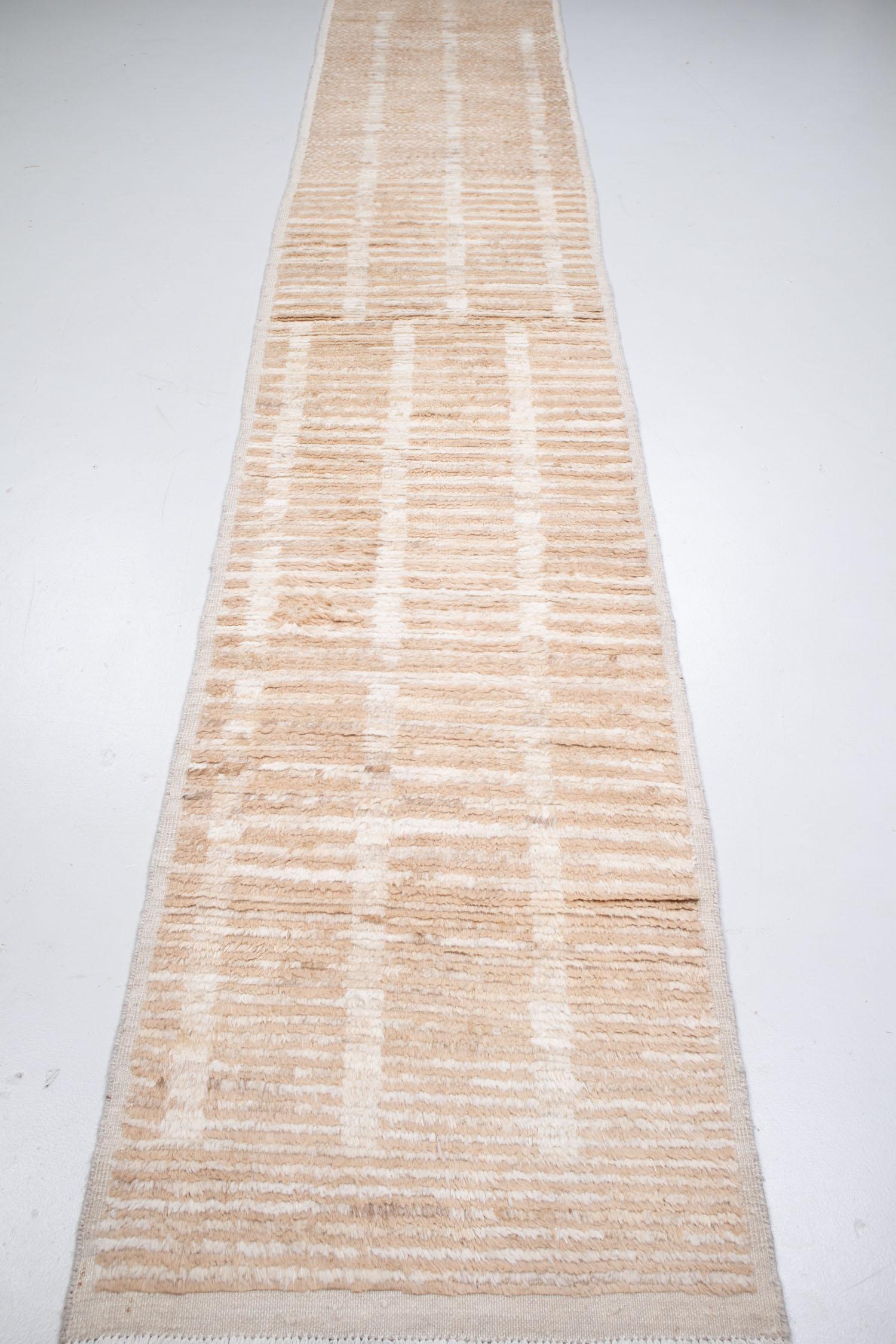 Expertly crafted by hand using 100% wool, this new production Tulu runner has a warm beige and sandy color palette. We love the elegantly understated pattern that is unique and whimsical.