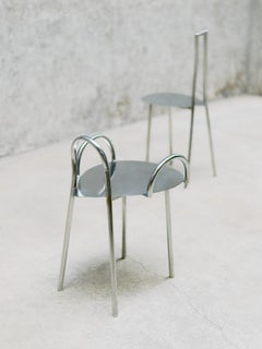 "Tumble" Chair in stainless steel tube and polished seat.