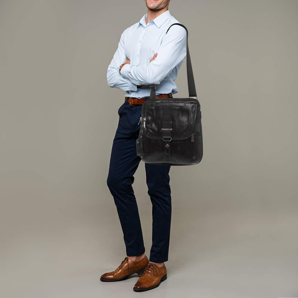 The TUMI messenger bag is a versatile and stylish accessory. Crafted from high-quality black leather, it features a zip-top closure, adjustable shoulder strap, multiple pockets for organization, and expandable capacity, making it a functional and