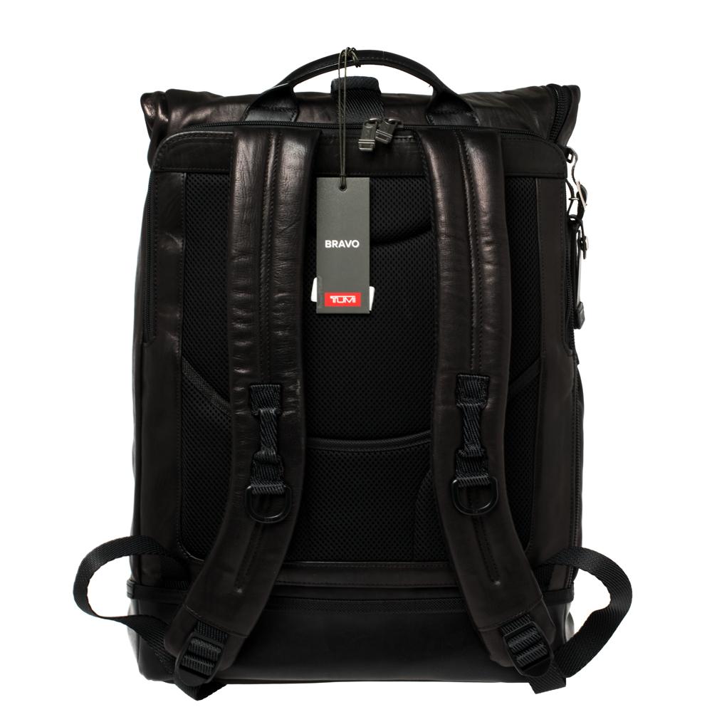 This durable and reliable backpack by TUMI is made from leather into a functional design. The bag features a roll top, zip pockets on the exterior, and a spacious main interior. It is complete with a flat top handle and adjustable shoulder