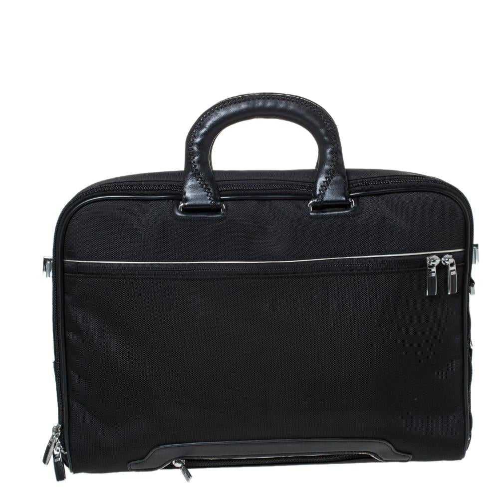 This Tumi laptop bag will carry all your essentials, whether headed to work or travelling around the world. Made from black canvas, its durable design features front zipped pockets, one back slip pocket and top leather handles. Its interior is lined