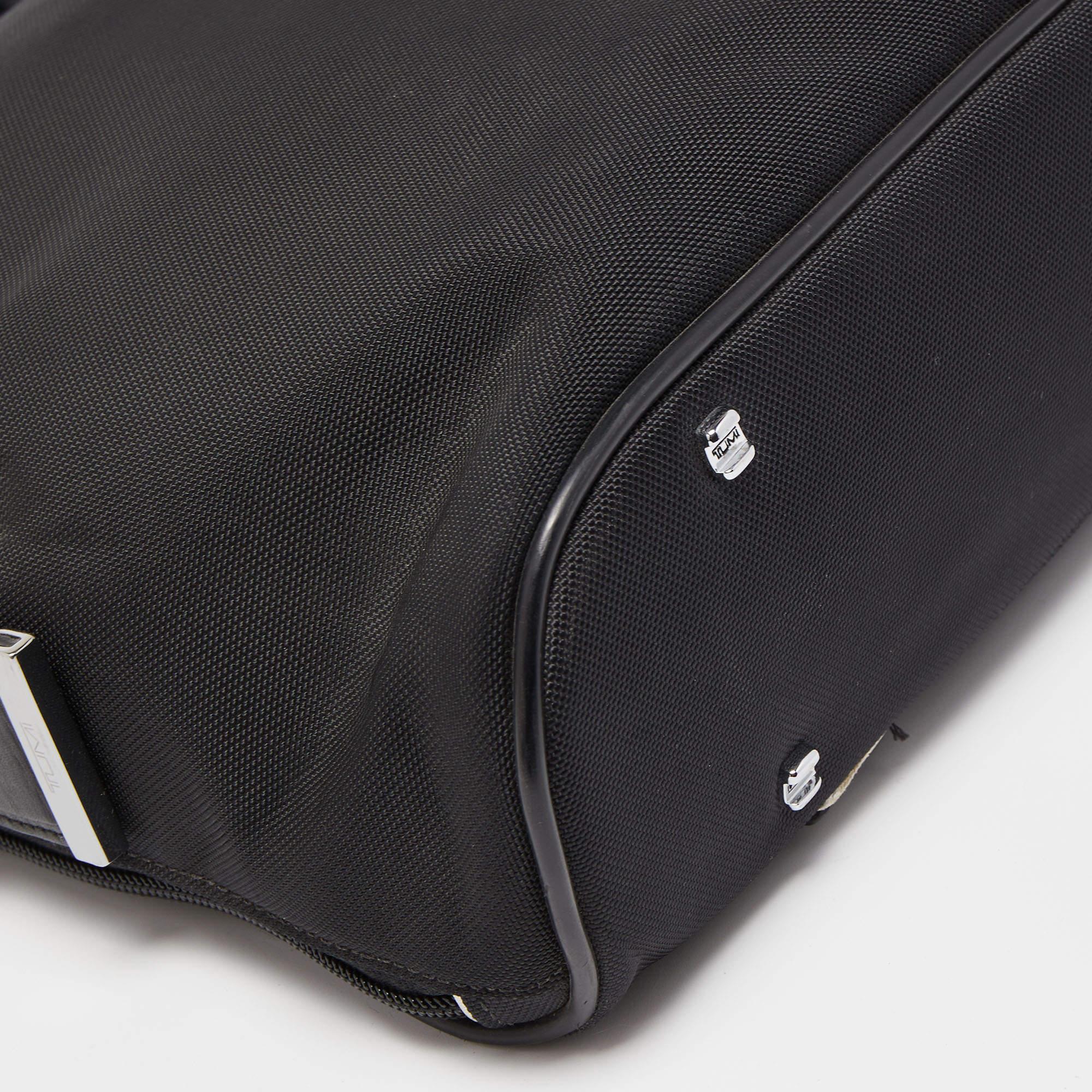 This TUMI laptop bag will carry all your essentials, whether headed to work or traveling around the world. Made from black nylon & leather, its durable design features front zipped pockets, top handles, and a shoulder strap.

