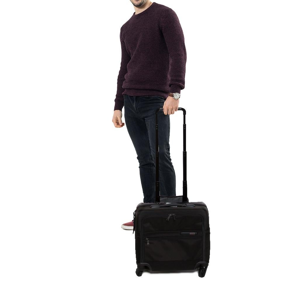TUMI is a brand par excellence when it comes to travel accessories! Crafted from high-grade nylon, plastic, and rubber, this luggage bag features front zip pockets, a telescopic handle, carry handle, and four wheels. The zip closure opens to a nylon