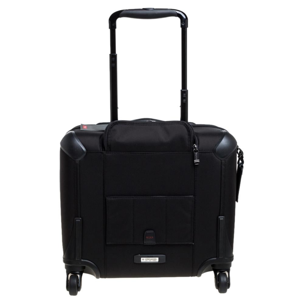 TUMI is a brand par excellence when it comes to travel accessories! Crafted from high-grade nylon, this luggage bag features front zip pockets, a telescopic handle, carry handle, and four wheels. The zip closure opens to a nylon interior furnished