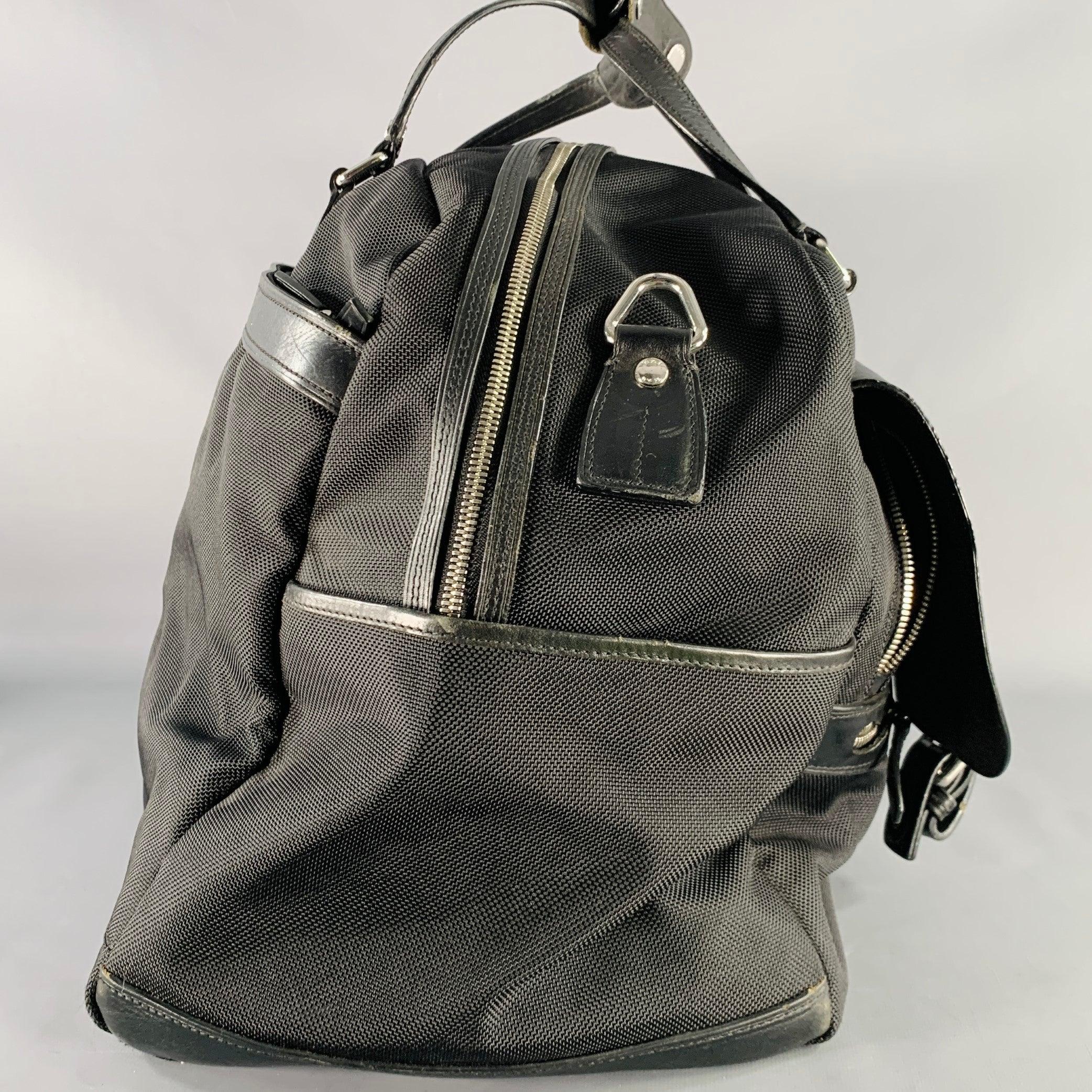 Bolsa de viaje TUMI
en tejido de nailon negro y piel negra, con un espacioso compartimento interior principal, asas superiores de piel y cierre de cremallera.Buen estado de segunda mano. Los imanes del bolsillo delantero no funcionan. Este bolso se