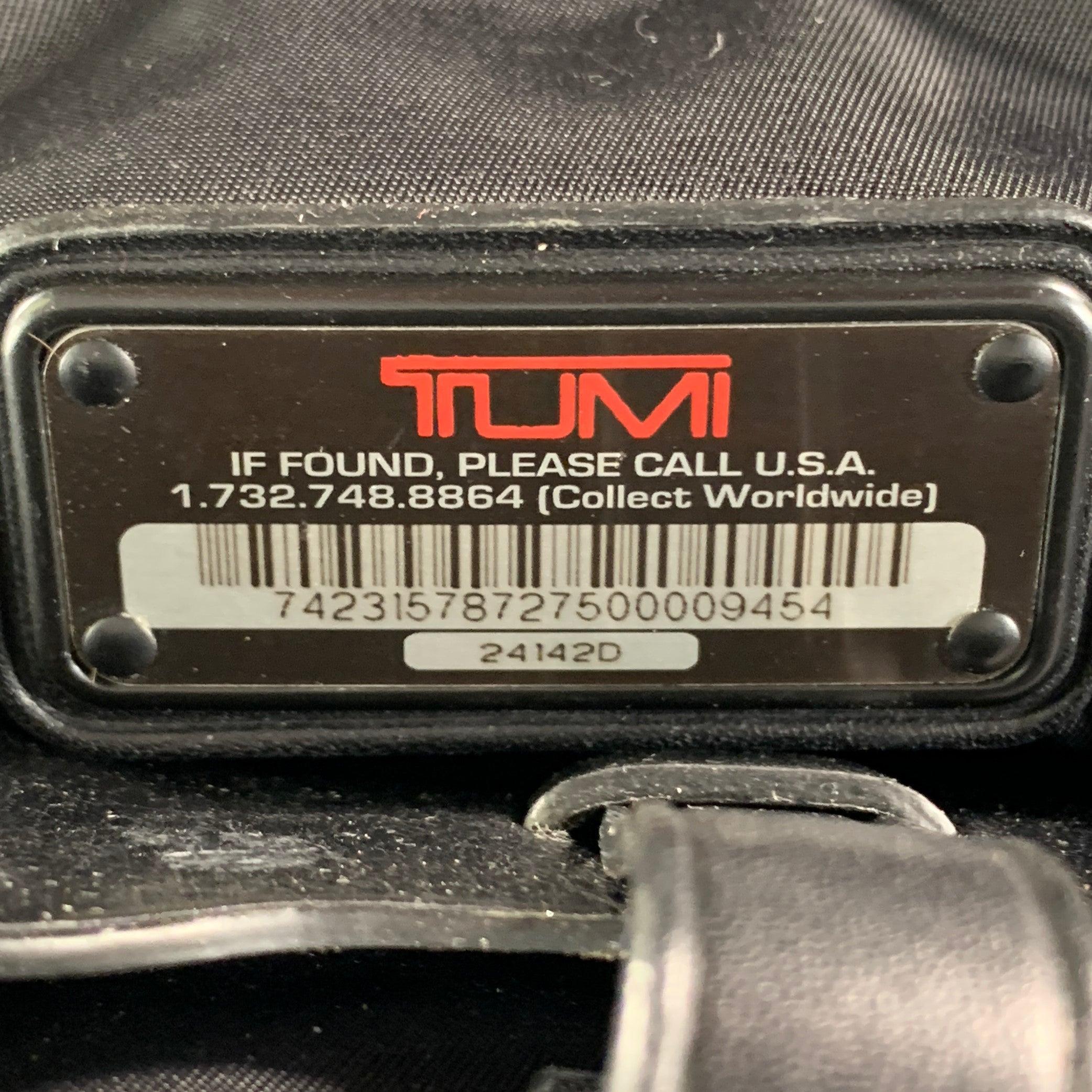 TUMI Bolsa de viaje con asas superiores de piel y nylon negro en venta 1
