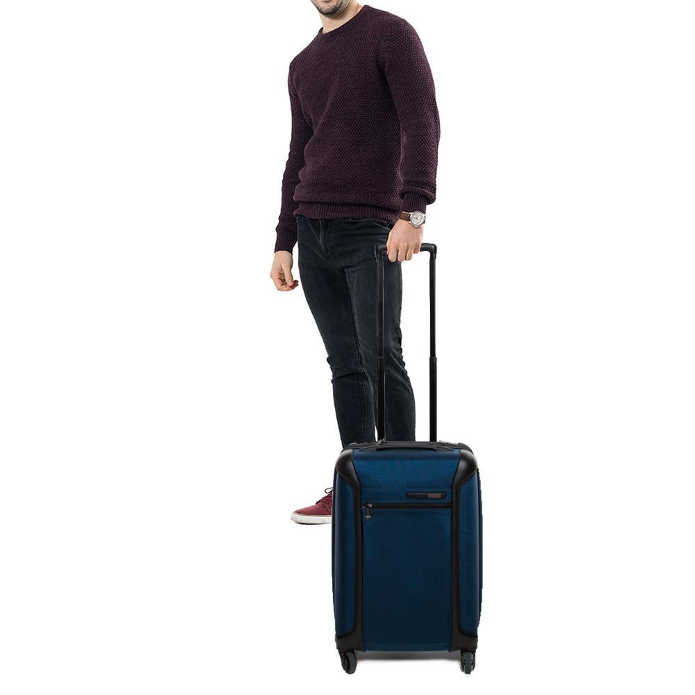 Look fashionably ready and equipped with your in-flight essentials with this Tumi Carry-On luggage. Crafted in blue nylon fabric, this International piece is accented with black trims. With a zippered pocket at the front, this four-wheeled trolley