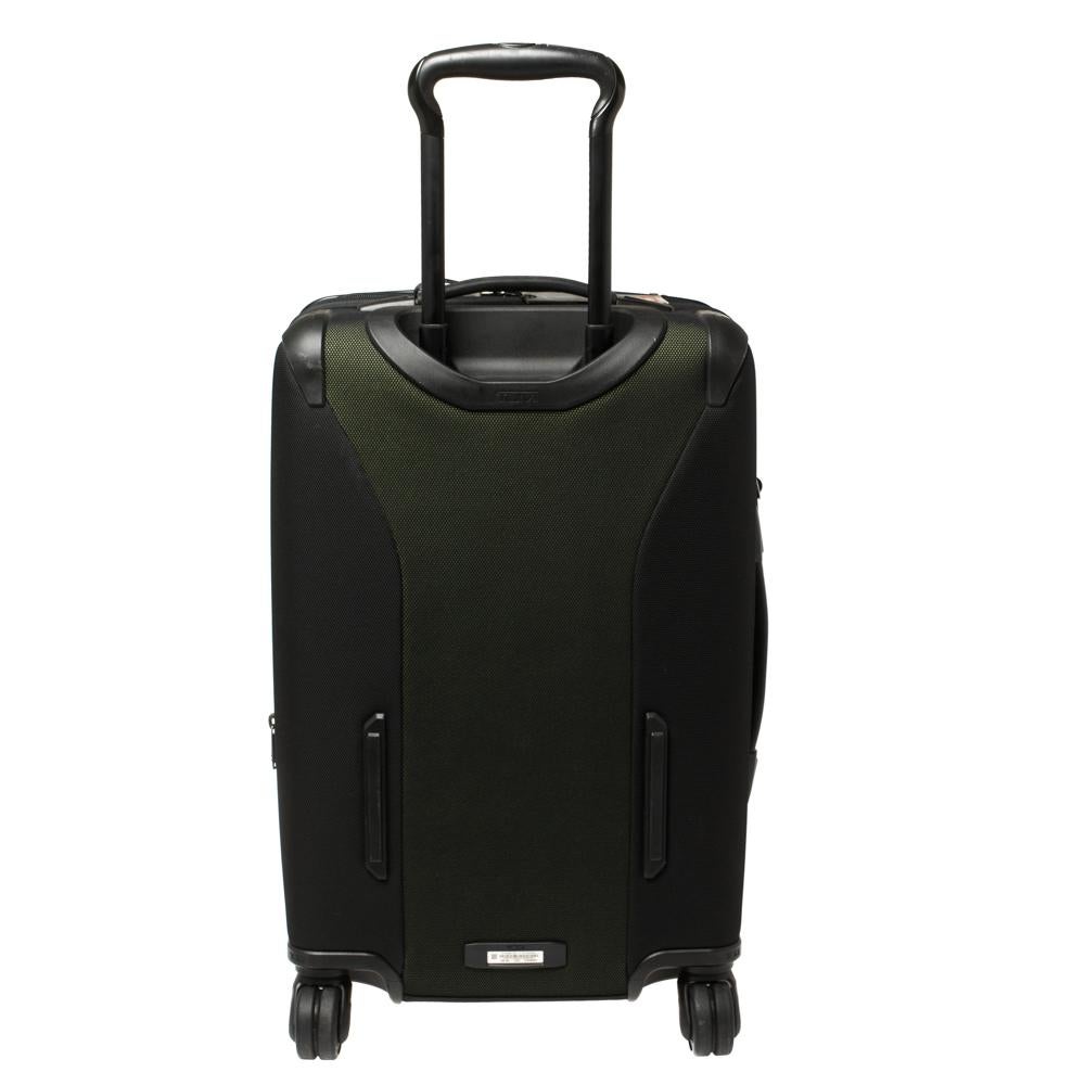 Travel in style with this TUMI trolley suitcase. This bag in metallic green and black has a telescopic handle, four wheels, and a spacious interior that can carry all your essentials. Offering great look and durability, this carry-on luggage bag