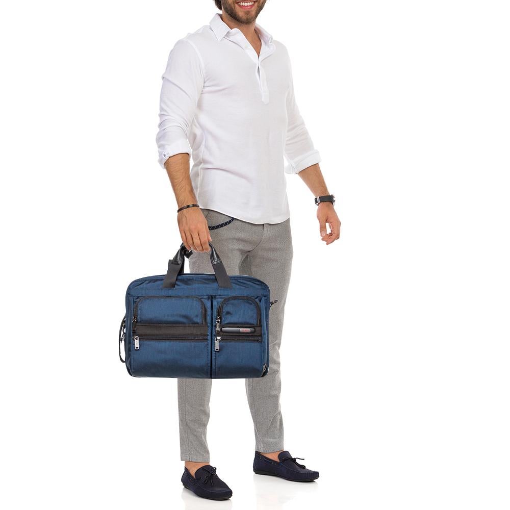 TUMI's Gen 4.2 Three Way bag is easy to style and easier to handle. Fashioned in nylon, the briefcase bag can be carried by dual top handles or with detachable shoulder straps like a backpack. Equipped with several pockets, it is highly versatile in