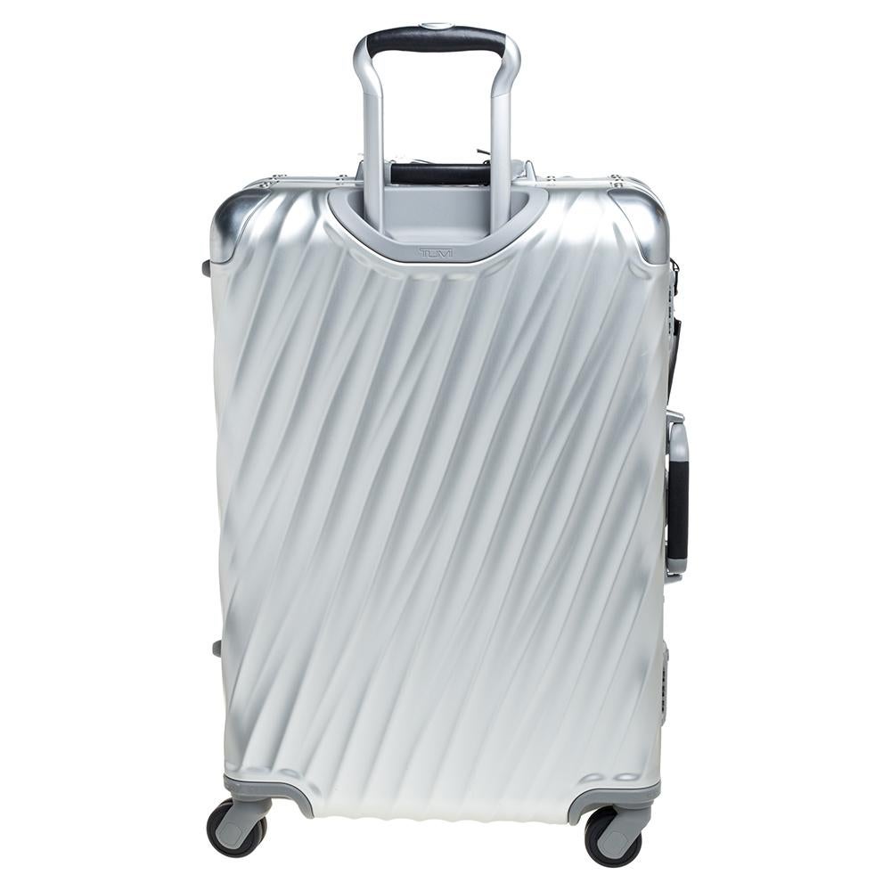 This 19 Degrees packing case from TUMI is made from silver aluminum. Equipped with four wheels that offer unrestrained movement, the bag has a top carry handle along with zippers to ensure security. It boasts a nylon-lined spacious interior that has