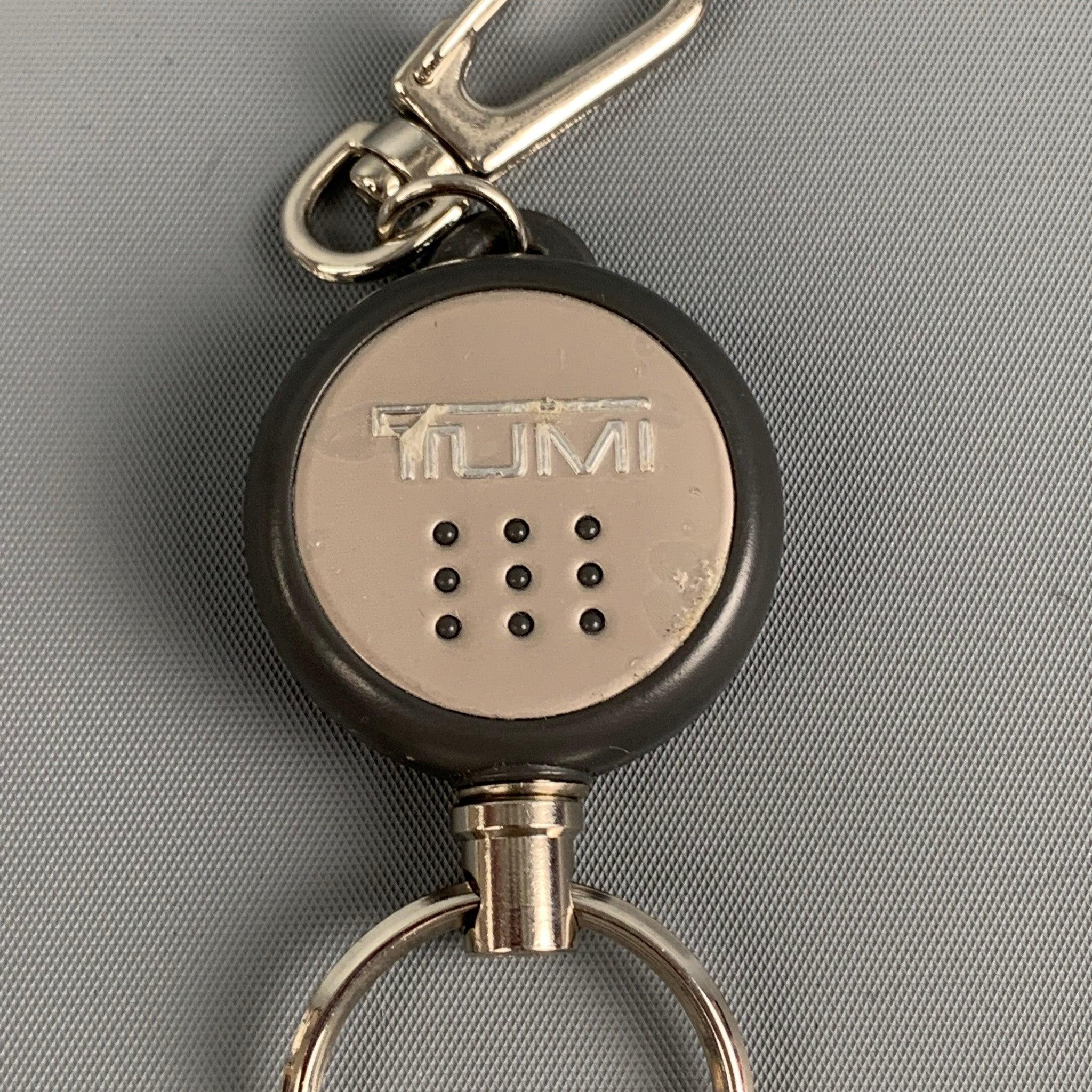TUMI key ring comes in a silver metal featuring a clasp closure.
Good Pre-Owned Condition. Light wear. As-Is.  

Measurements: 
  Width: 1.25 inches  

  
  
 
Reference: 118838
Category: Bags & Leather Goods
More Details
    
Brand:  TUMI
Color: 