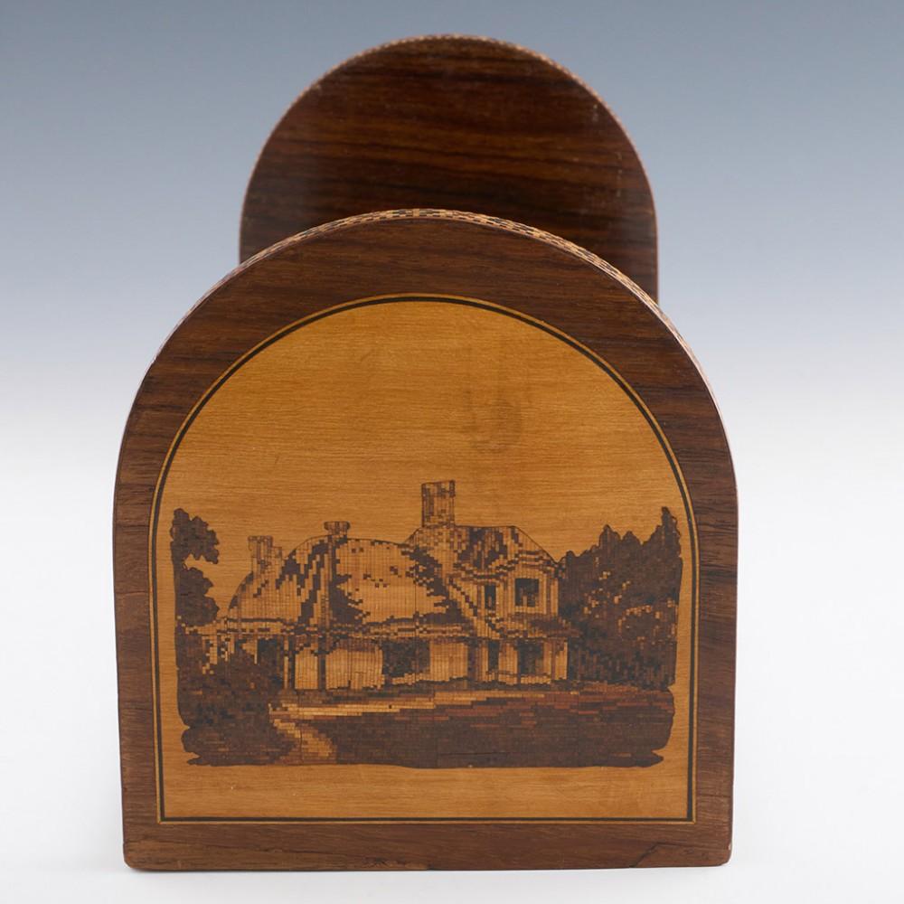 Heading : Tunbridge ware boosklide featuring Glena Cottage
Date : c1880
Period : Victoria
Origin : Tunbridge Wells, Kent
Decoration : One panel is decorated with perspective cubes, the other with an image of Glena Cottage, Killarney. The sides of
